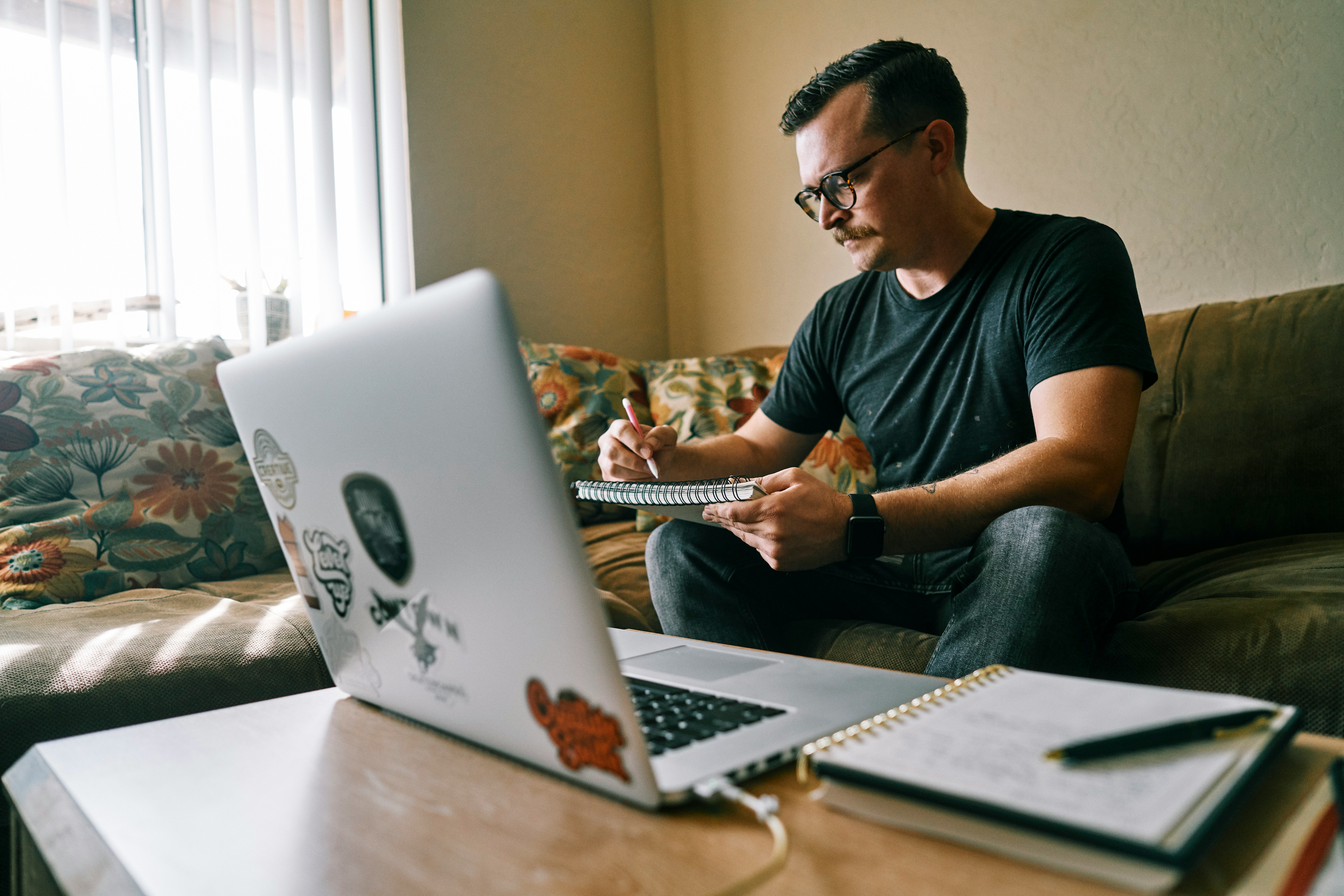 man in black crew neck t-shirt using macbook