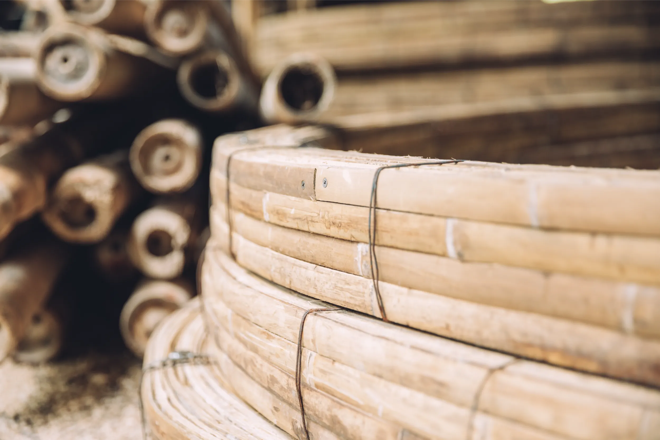 Detail of curved bamboo strips bundled for fabrication, demonstrating the material flexibility used in Arquitectura Mixta's organic architectural forms and parametric structures.