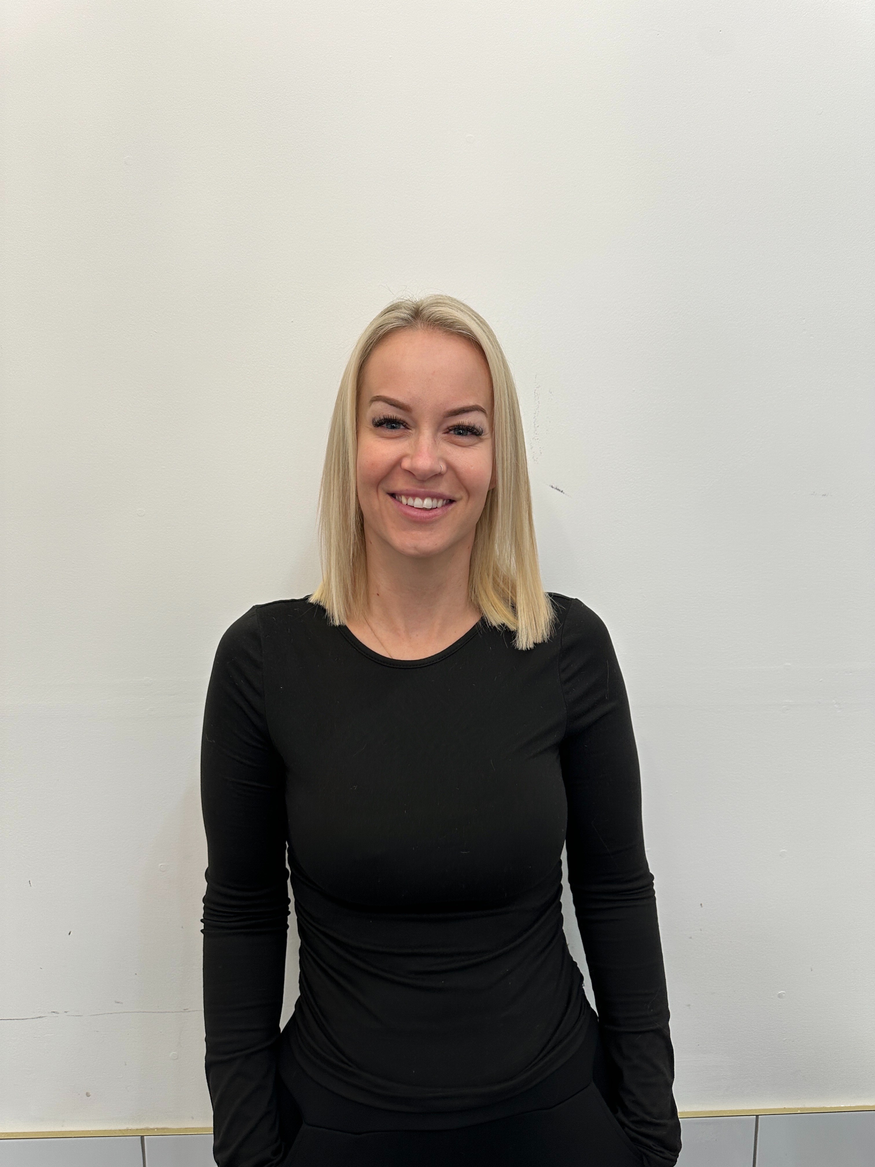 Salon Owner with blonde hair smiling