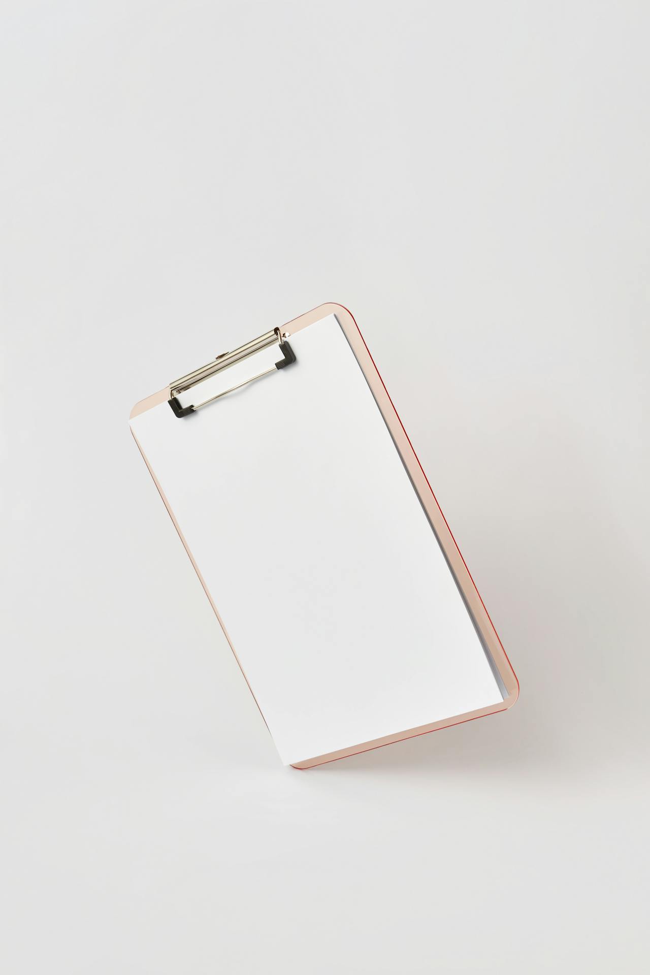 Clipboard and pen on an office desk, suggesting dated test records and verification.