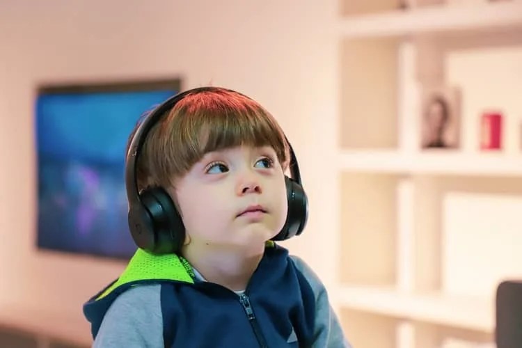 a boy listening to something via headphones
