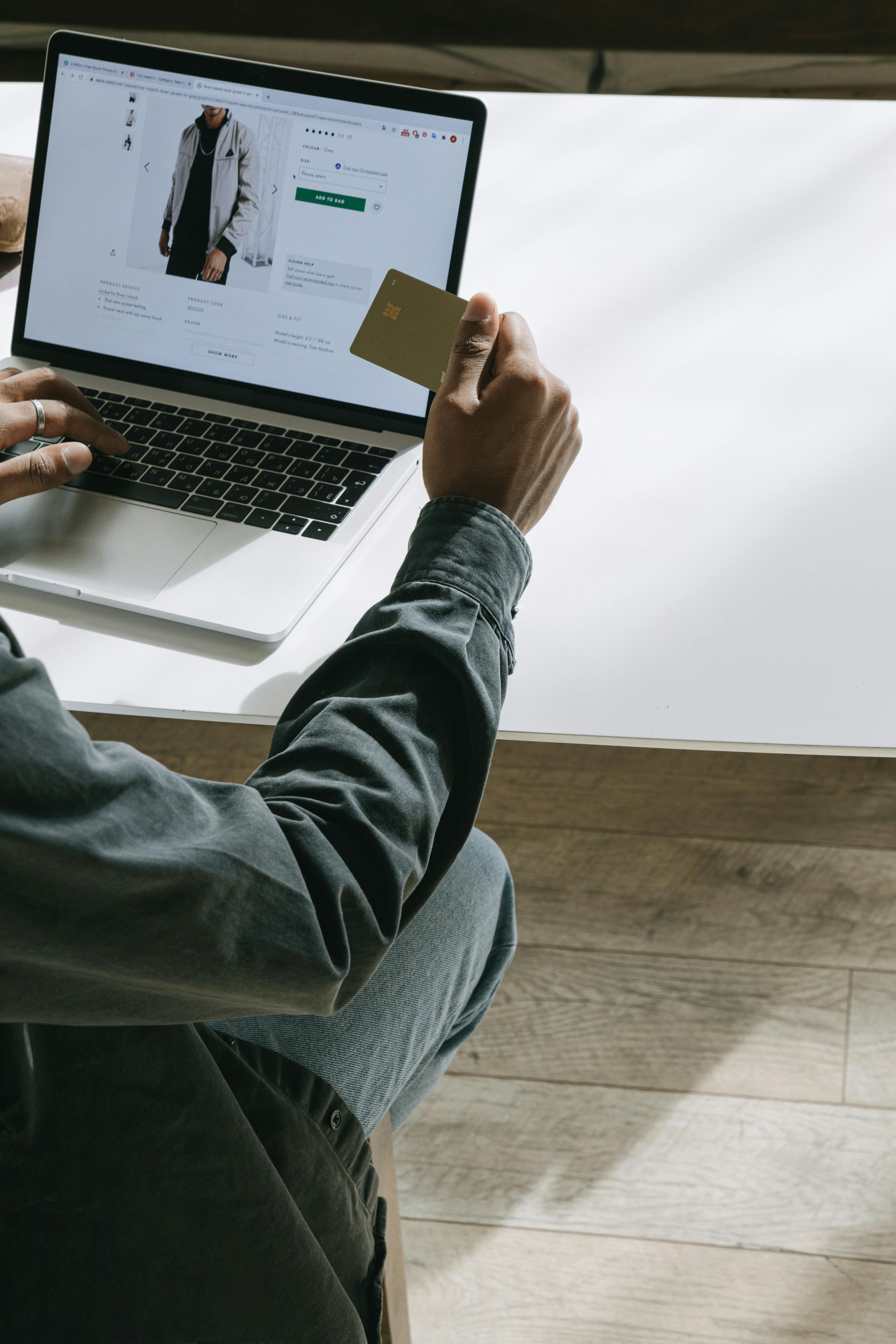 Aerial view of a winding road cutting through rocky terrain and sandy landscape.