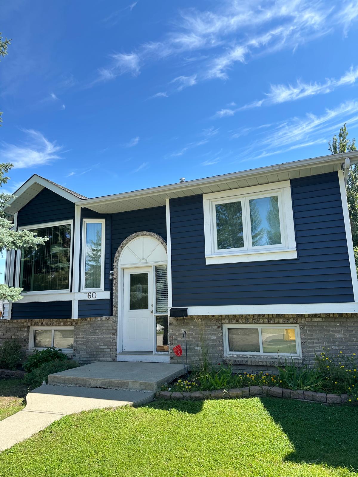 Split-level home in Harvest Hills re-sided in durable vinyl with new vented soffit and fascia.