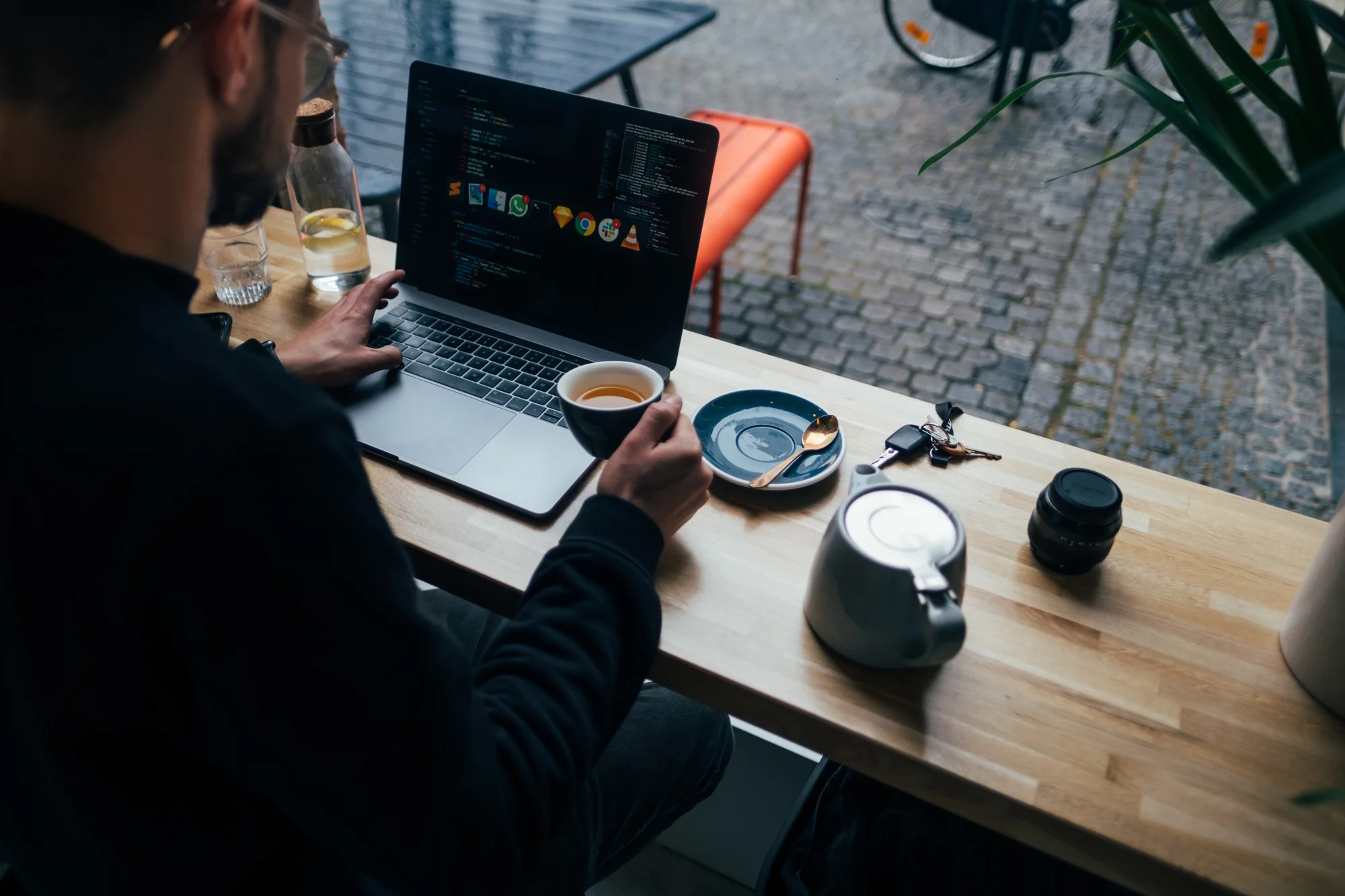 Professional in focused work mode with headphones and laptop