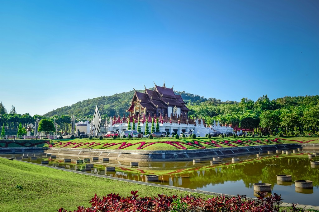 a large building sitting on top of a lush green field