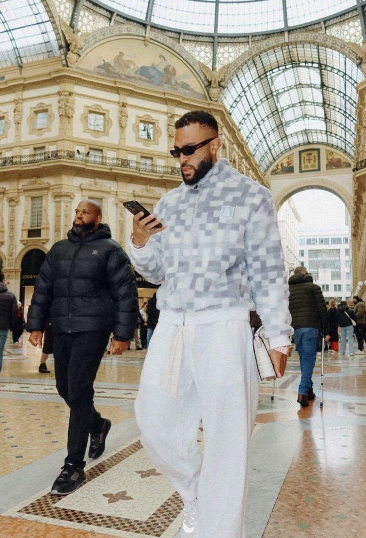 a man with a beard wearing a black hoodie