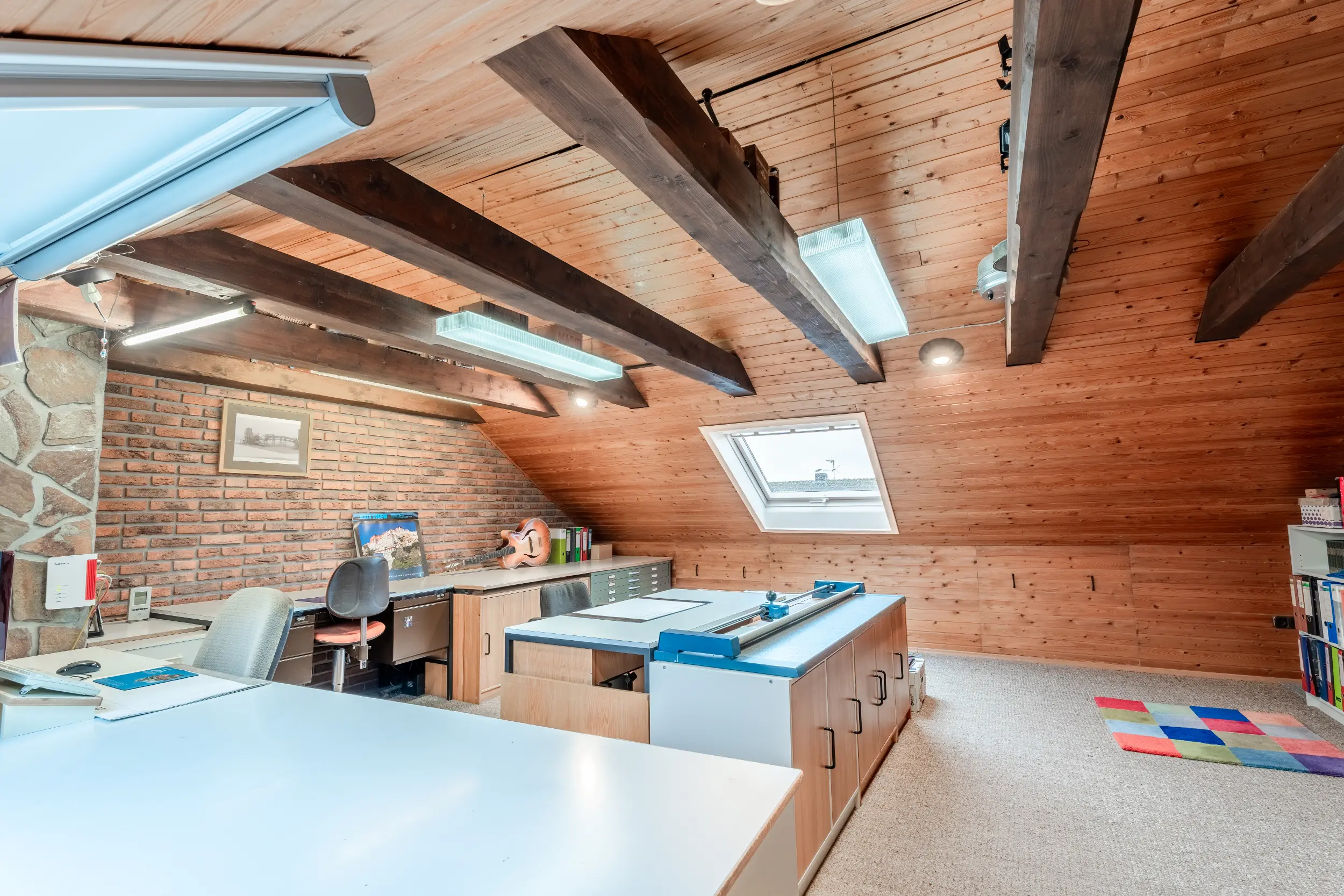 Großzügiges Dachgeschoss im Reihenmittelhaus in Raesfeld mit Holzverkleidung, freiliegenden Balken, Dachfenster und viel Arbeitsfläche.