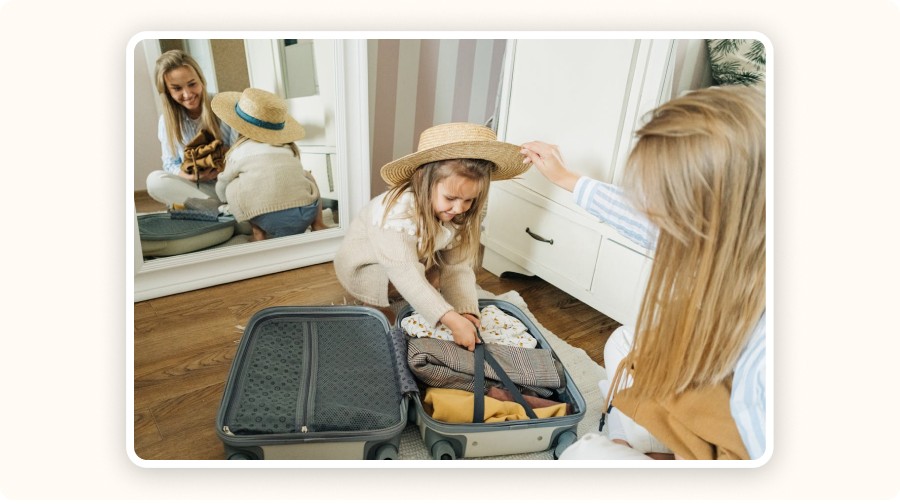 Mother and daughter packing a suitcase