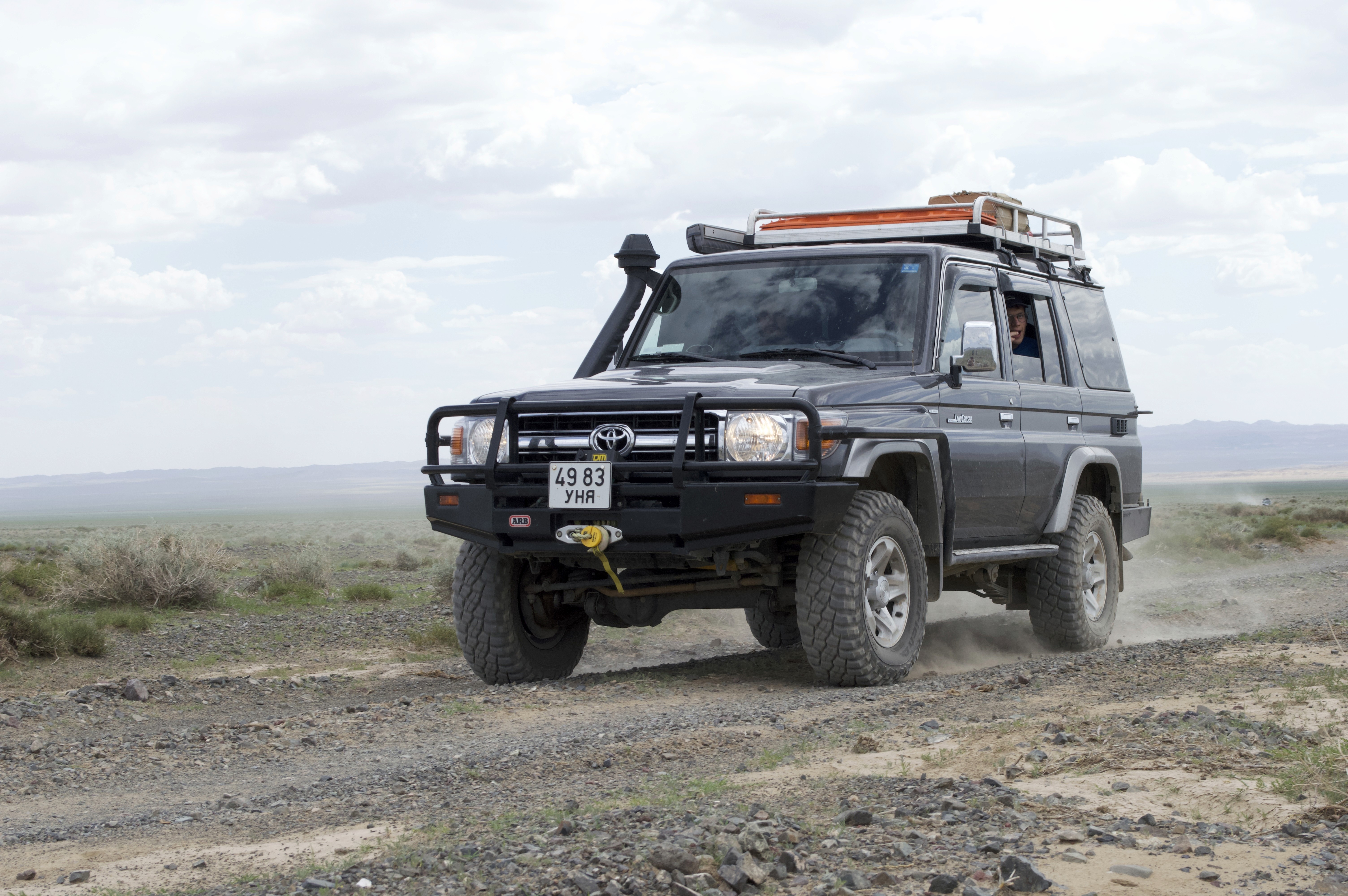 Offroad car cruising through the landscape of mongolia