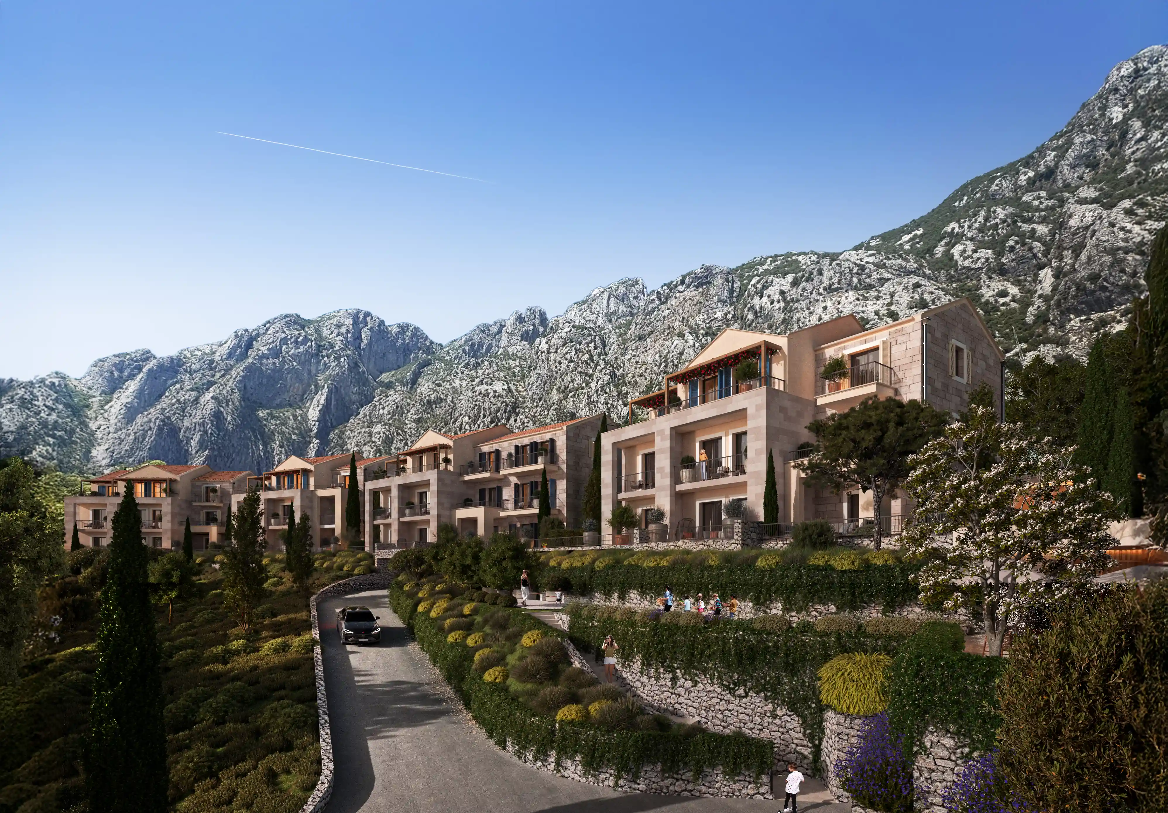 Mediterranean-style villas with terraced gardens set against a dramatic rocky mountain backdrop.