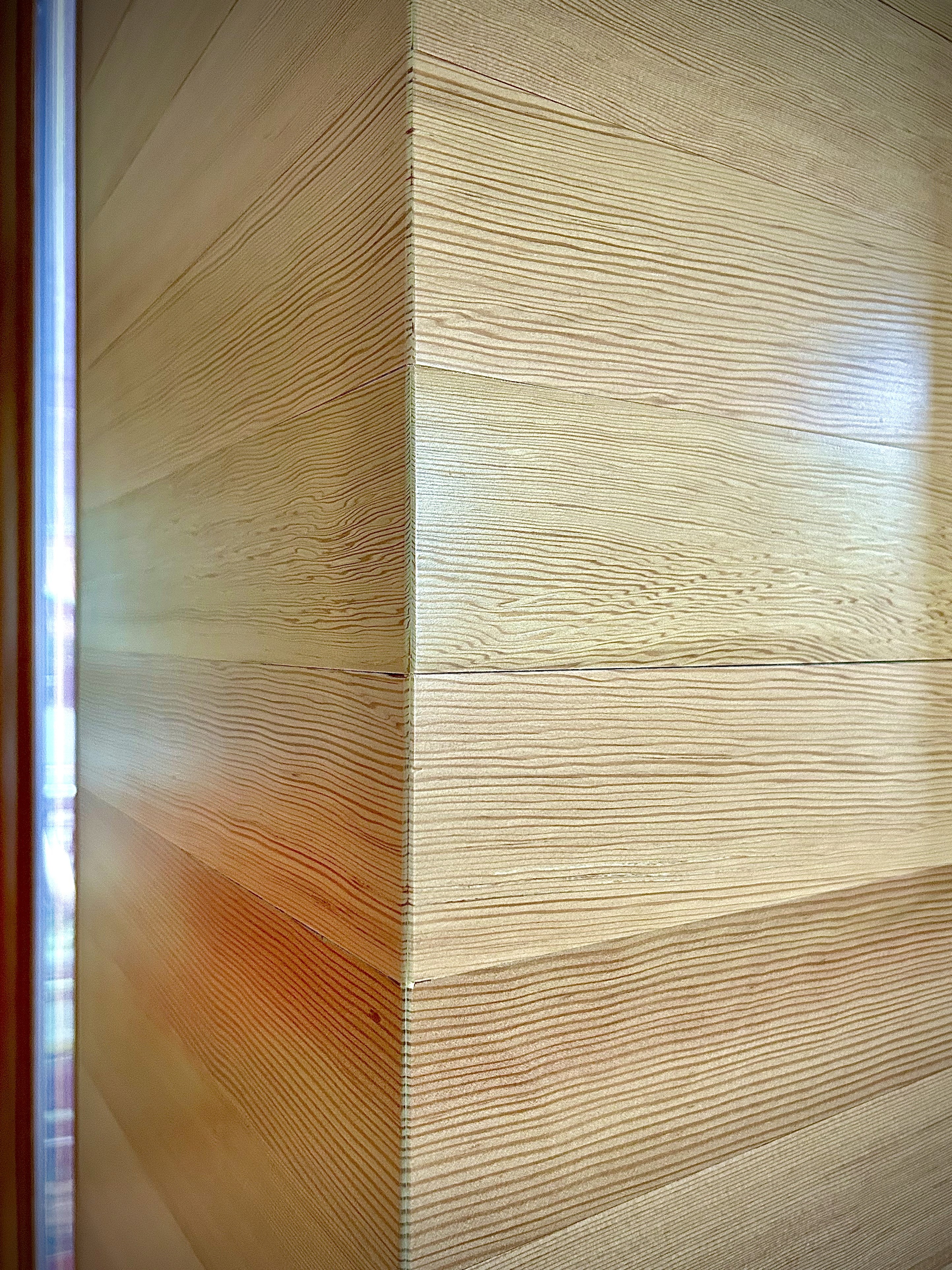 Detail of Douglas fir wall panel wrap showing wood grain.