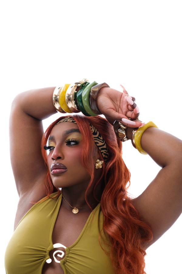 Close portrait of a model in a lime outfit and patterned headwrap
