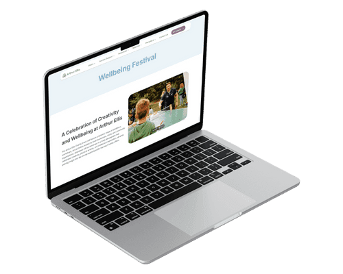 A side facing macbook, with the Arthur Ellis website on.