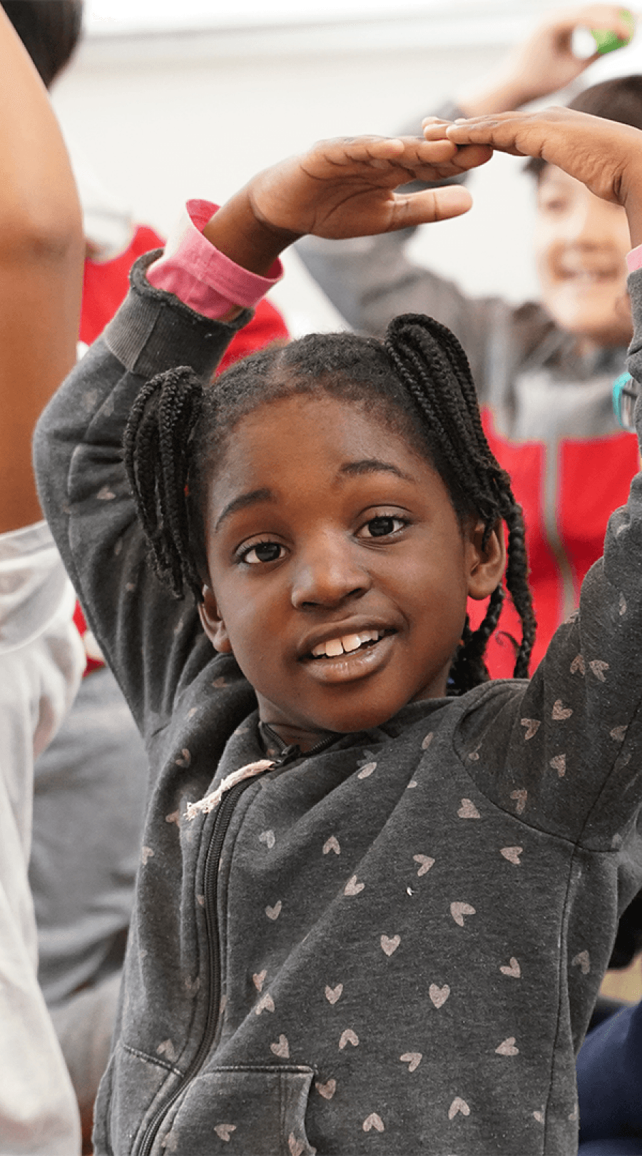 Student confidently participating in a HOKALI aftercare activity designed to encourage self-expression and joy.