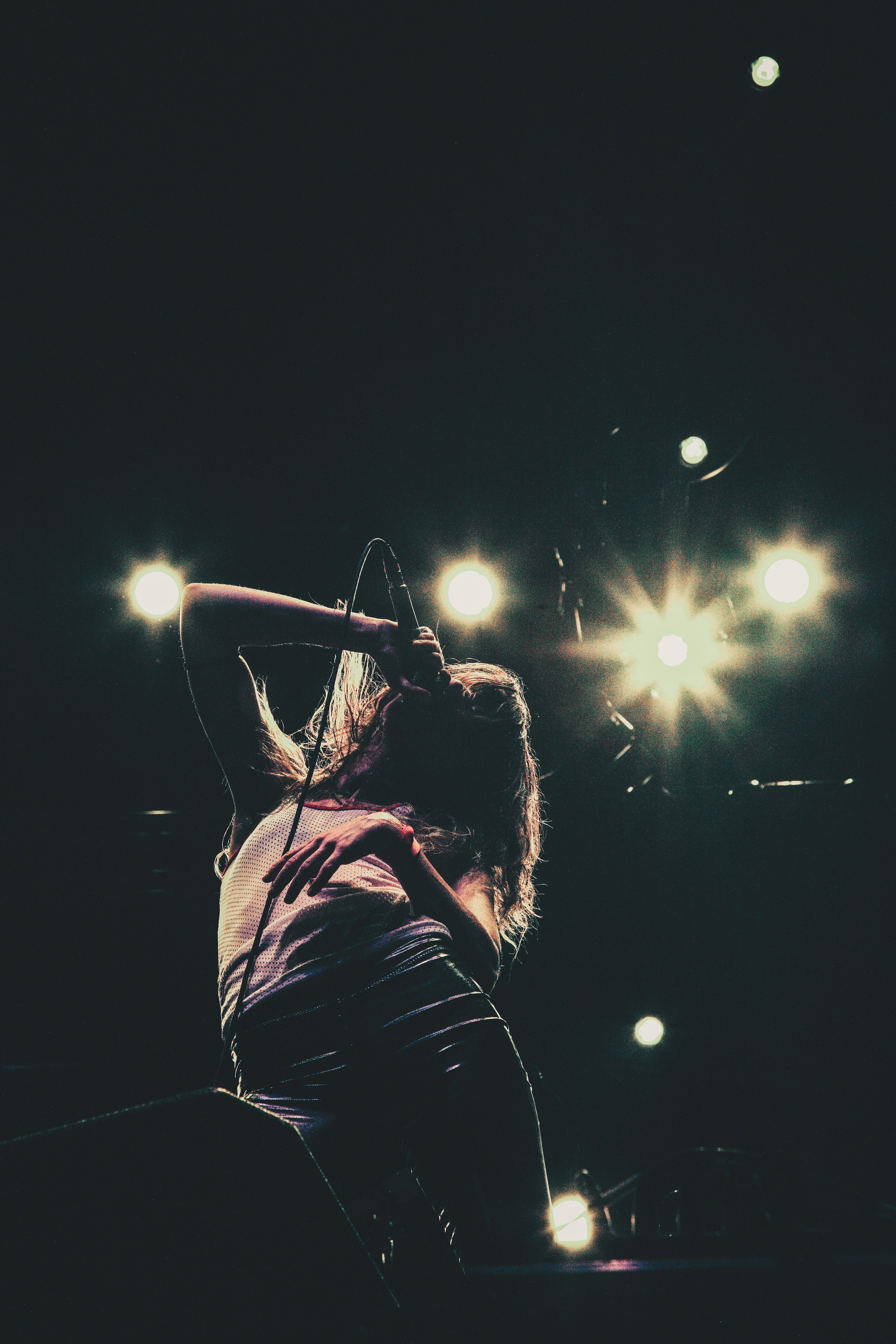 girl singing on microphone