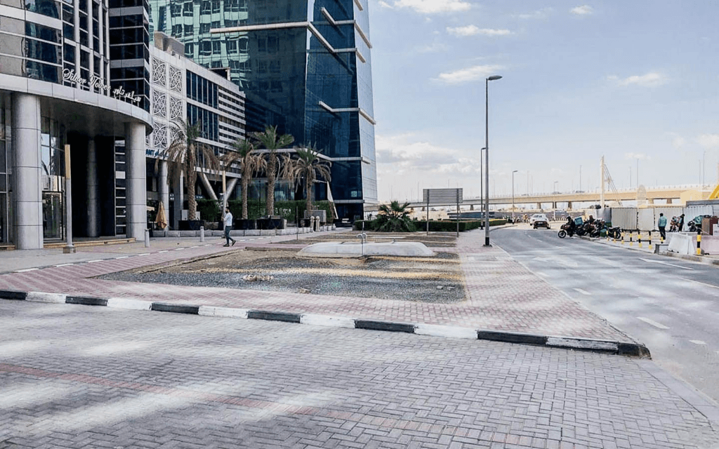 Scenic road view leading to Silver Tower with Burj Khalifa skyline, perfect for luxury property seekers.