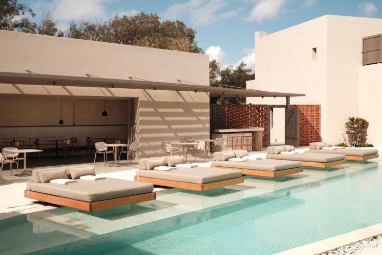 sunloungers fronting buildings near mountain