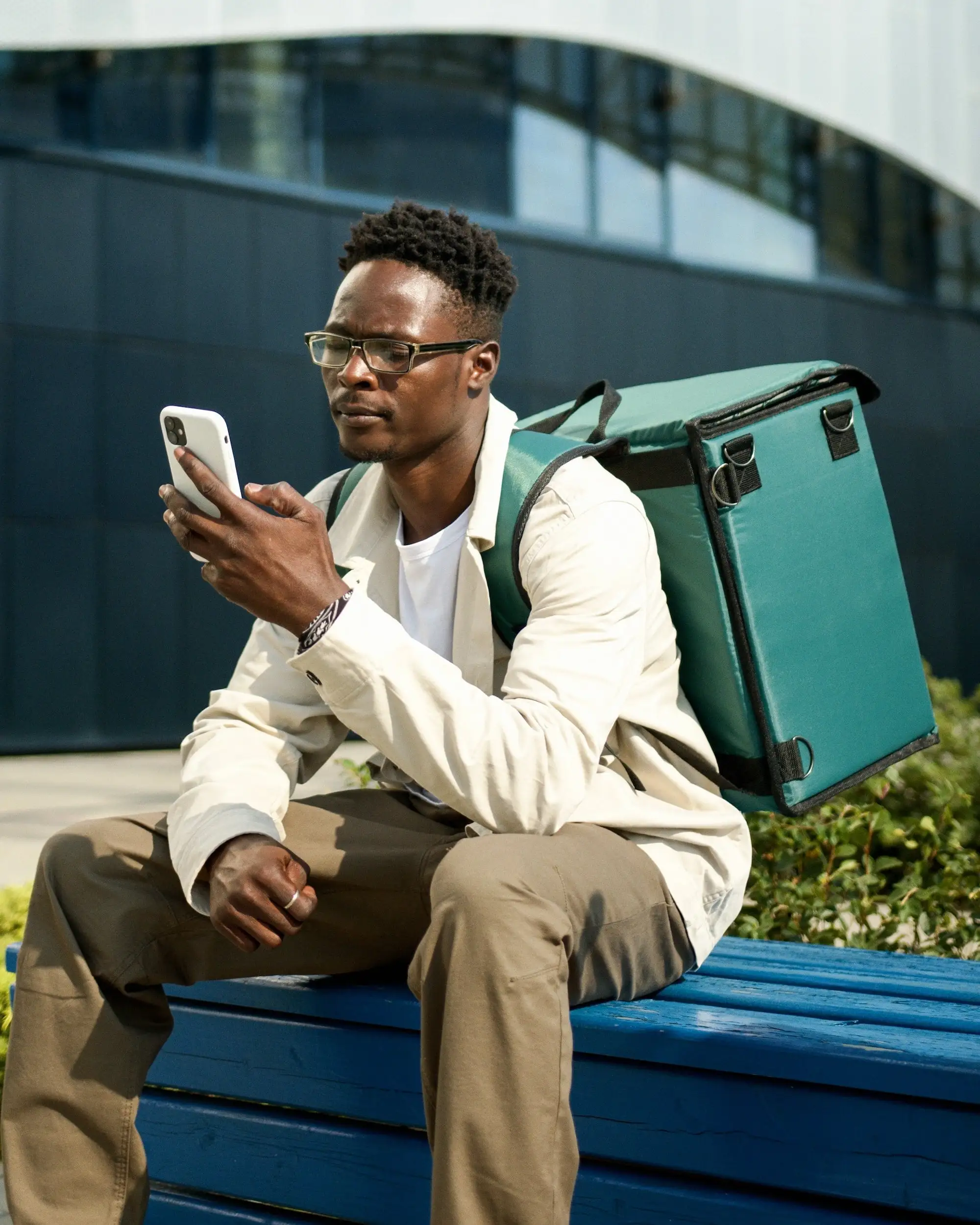 Photo of a delivery rider looking at his mobile phone