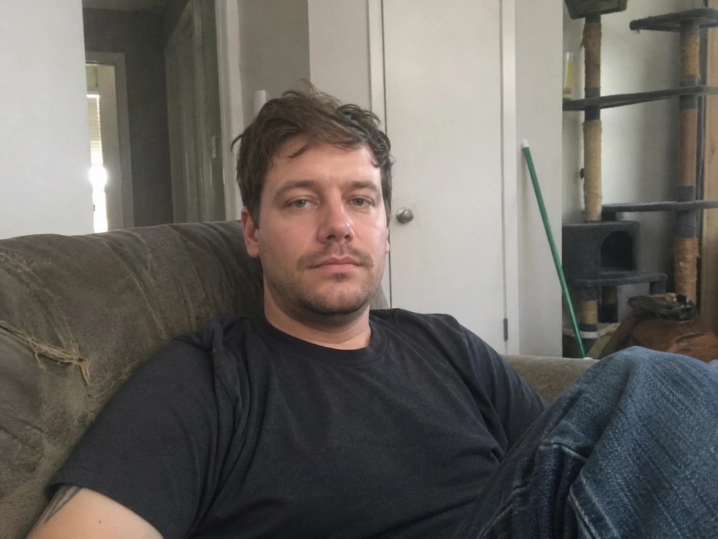 Man sitting on couch in casual black shirt