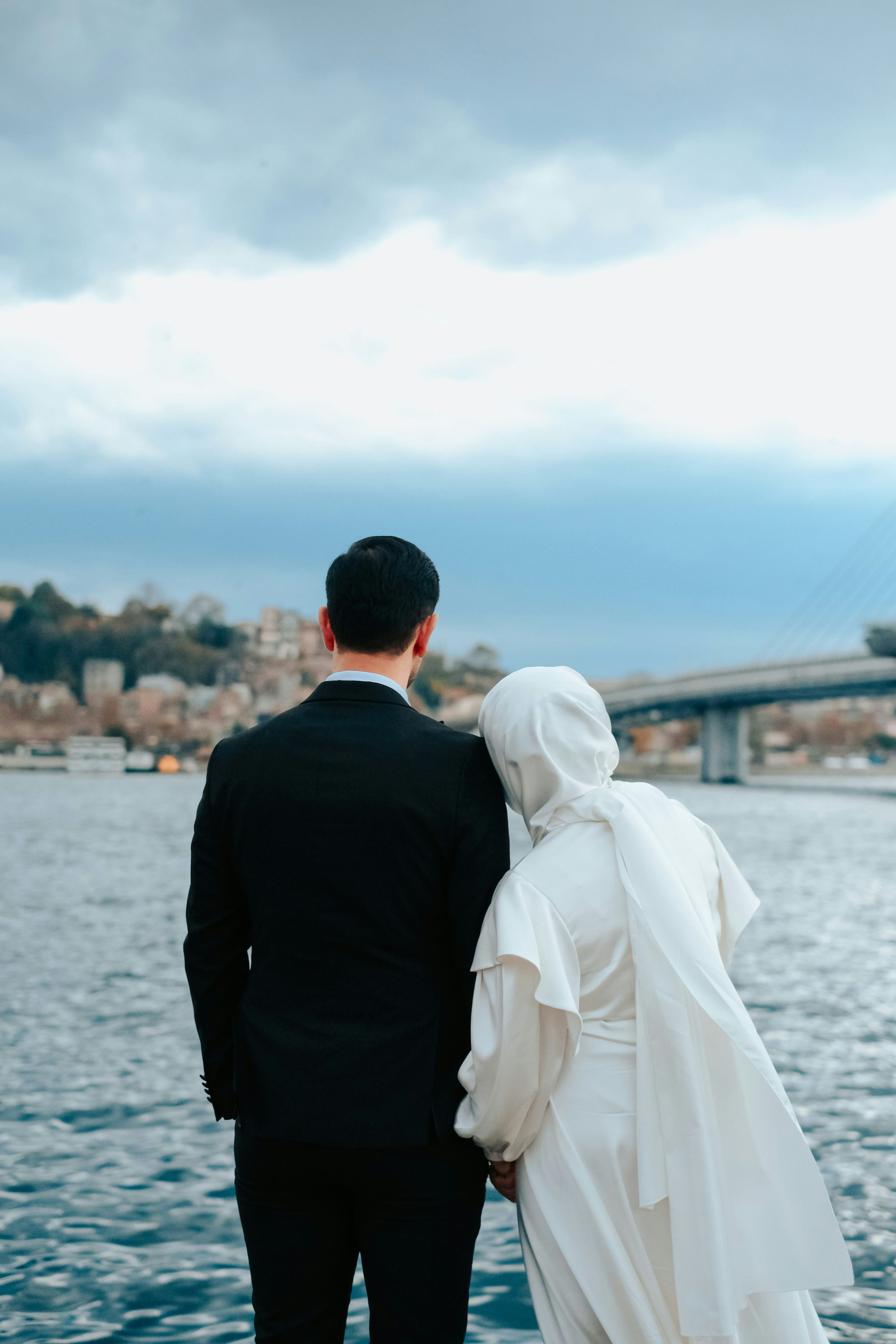 A couple next to a bridge