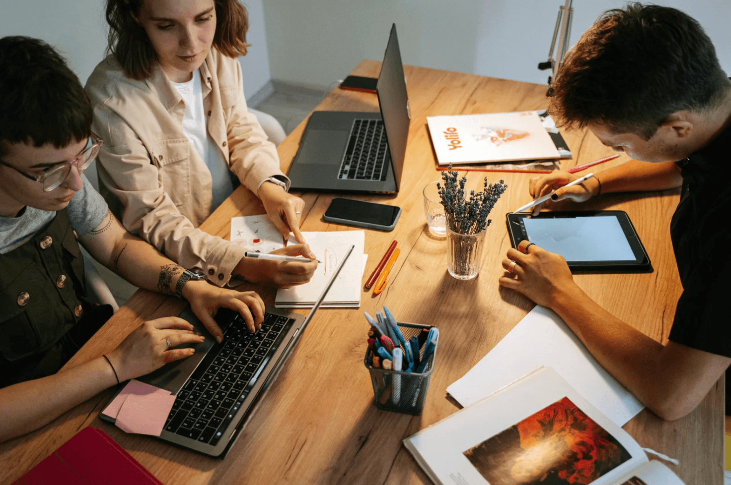 Team planning Amazon PPC structure with laptops and tablet, highlighting how manual builds can create keyword and ASIN overlap
