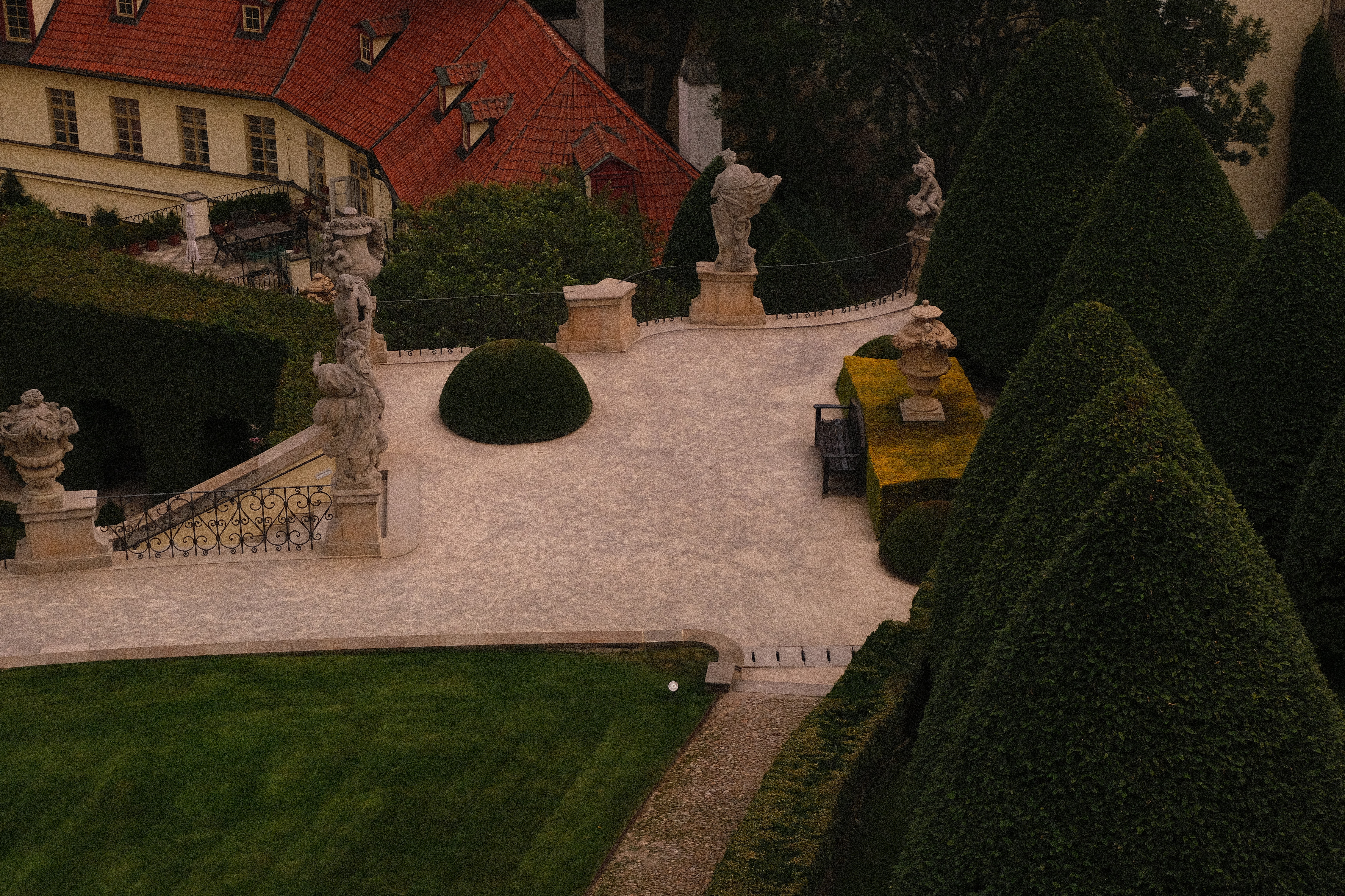 A view of a studio interior with modern decor, featuring large windows that offer a glimpse of lush greenery outside