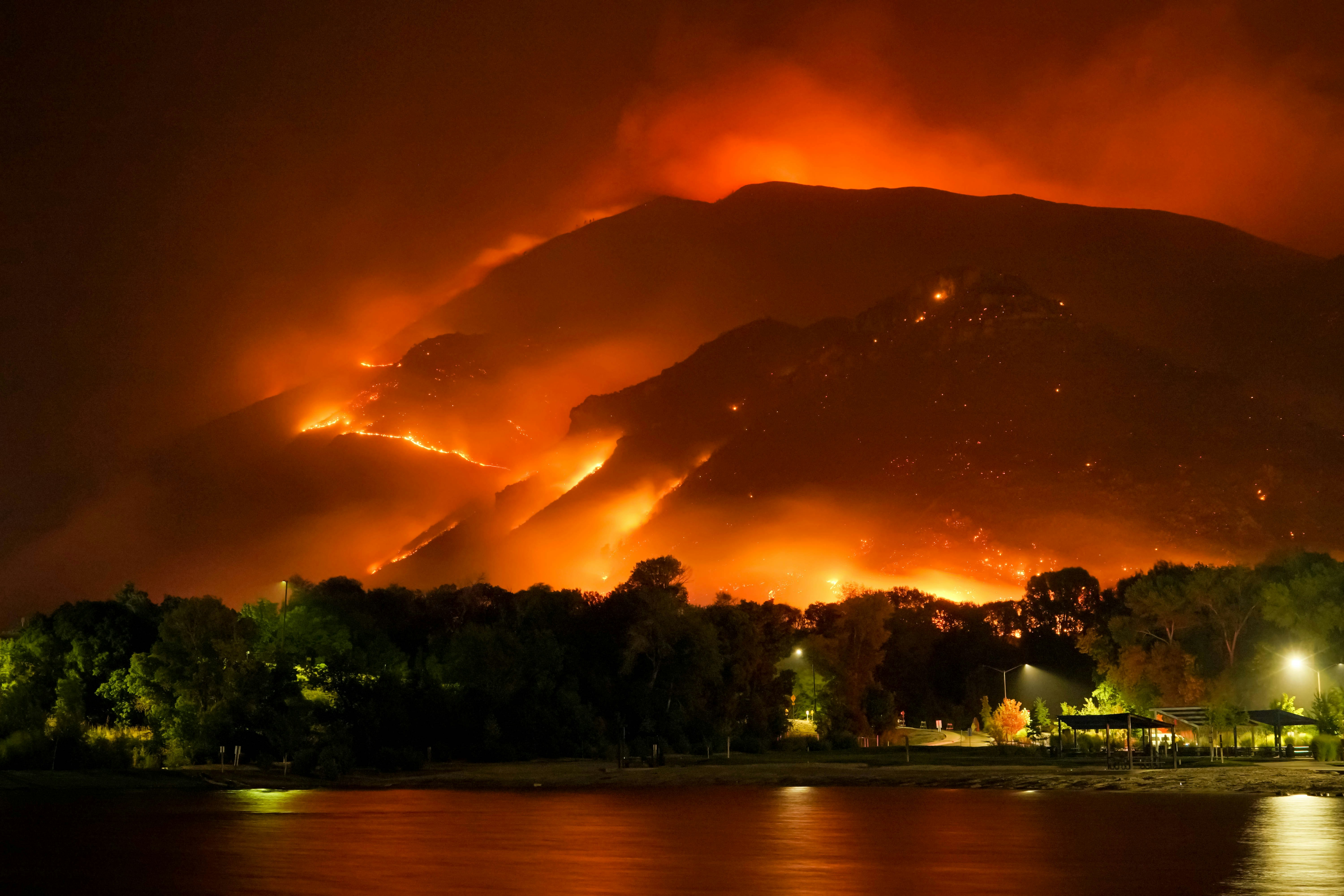 large wildfire in hills above a town