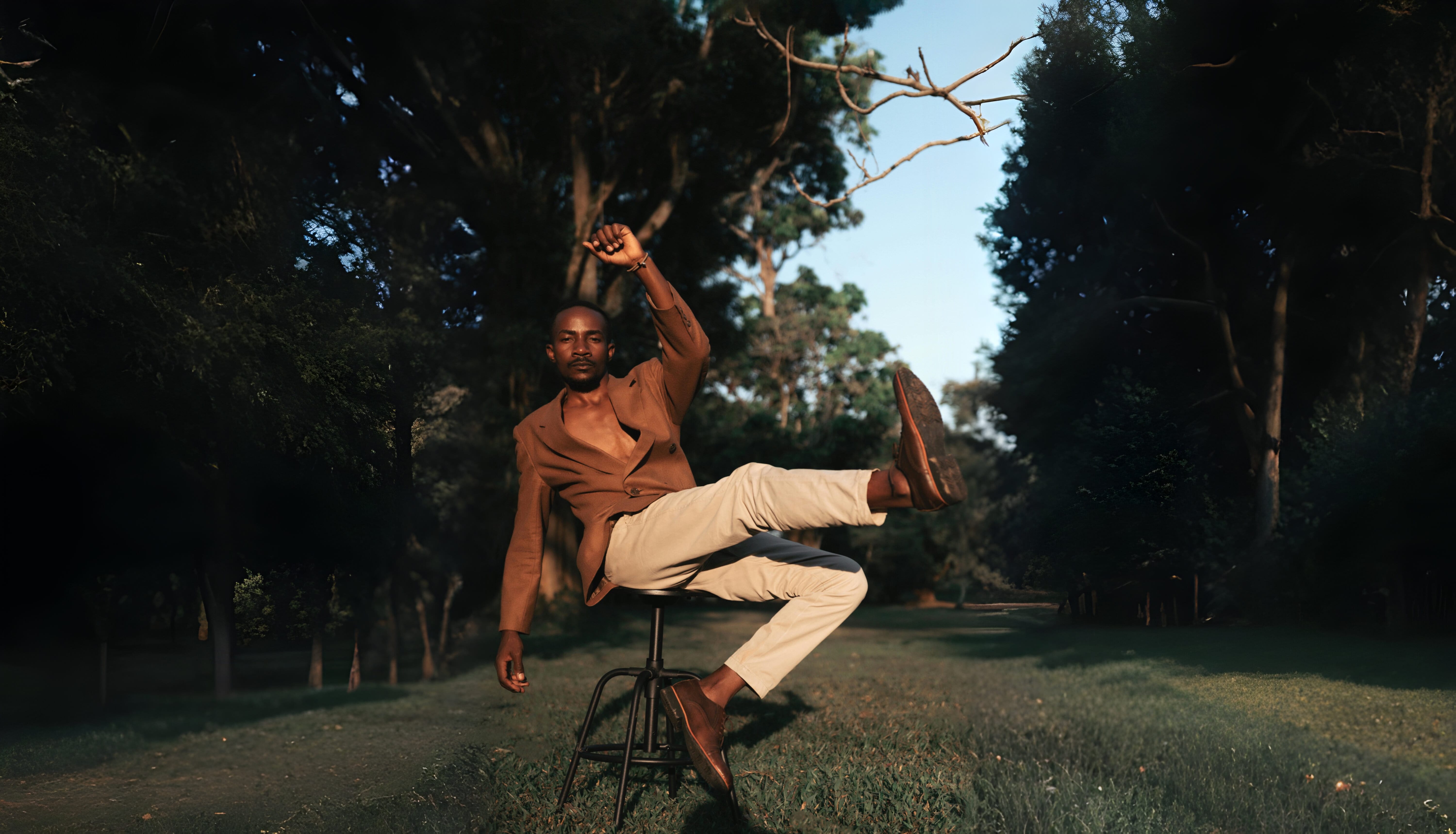 Man sitting posing on a barstool.