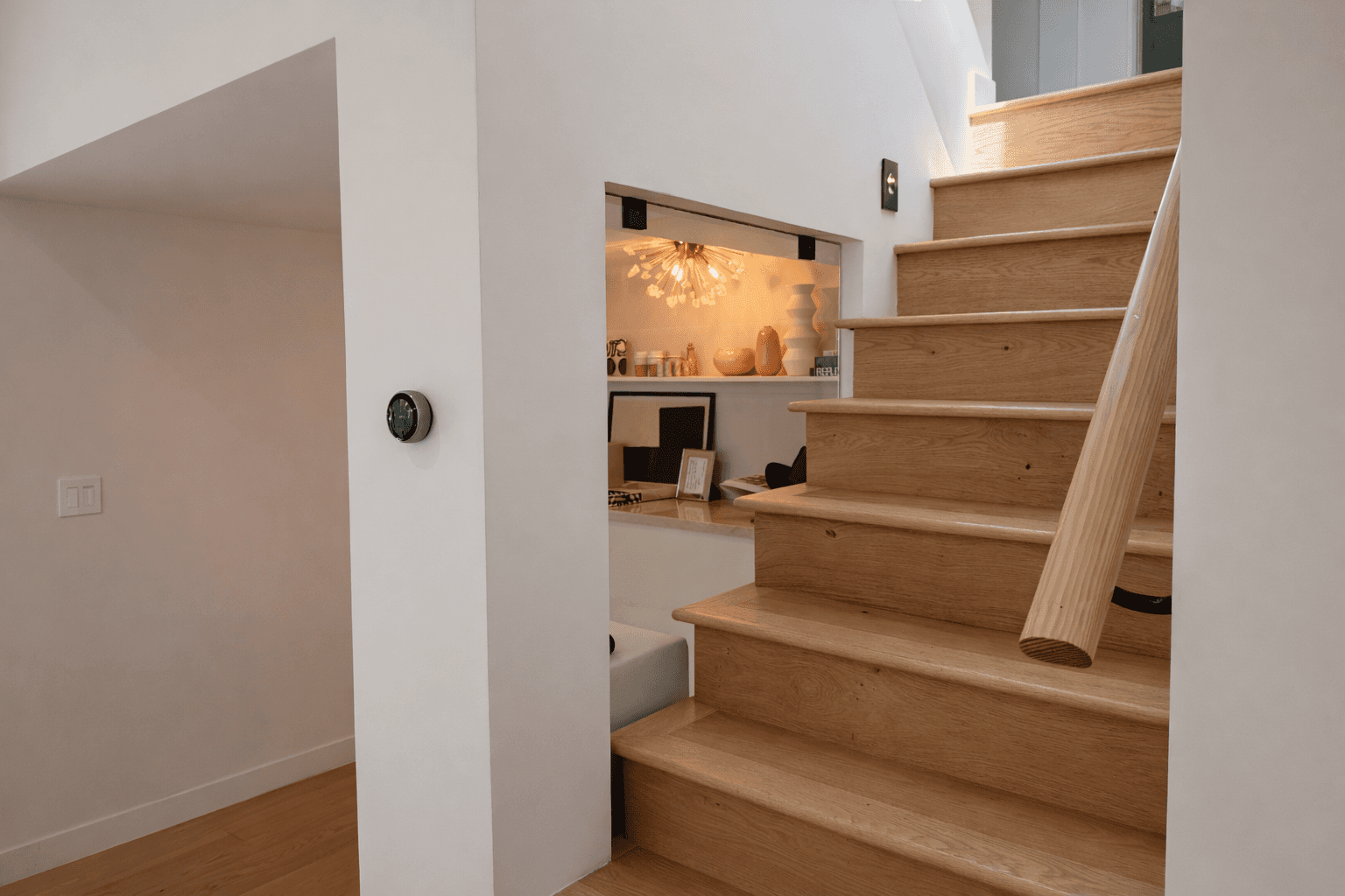 House with solar panels surrounded by forested hills