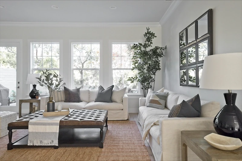 Inviting living room with plush sofas, herringbone rug, and large windows in Bonita Canyon Remodel.