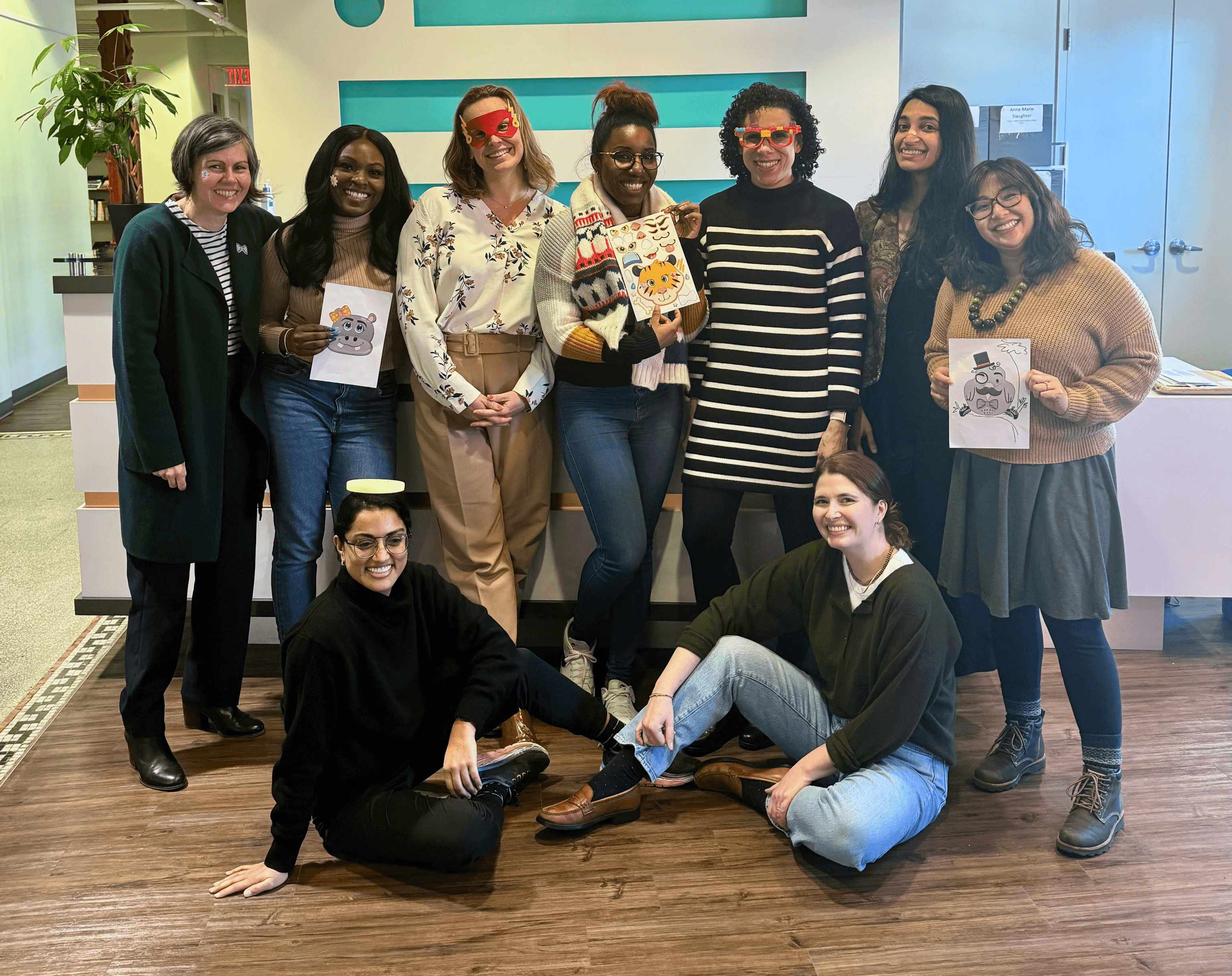 The New Practice Lab team standing in a group portrait staged in a modern office. 