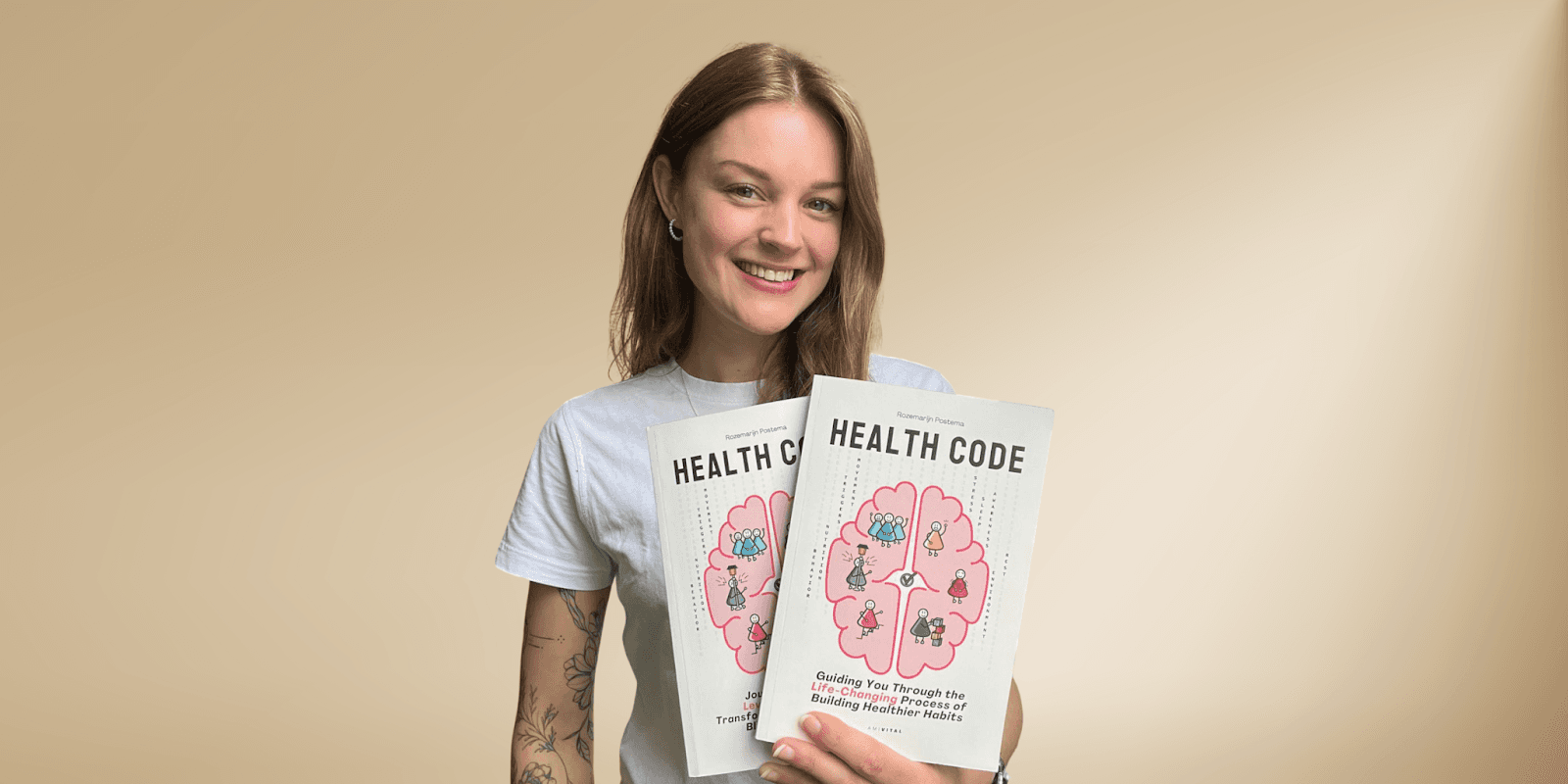 Rozemarijn Postema holds two copies of 'Health Code,' promoting AmiVital’s science-backed approach to consistent health and wellness.