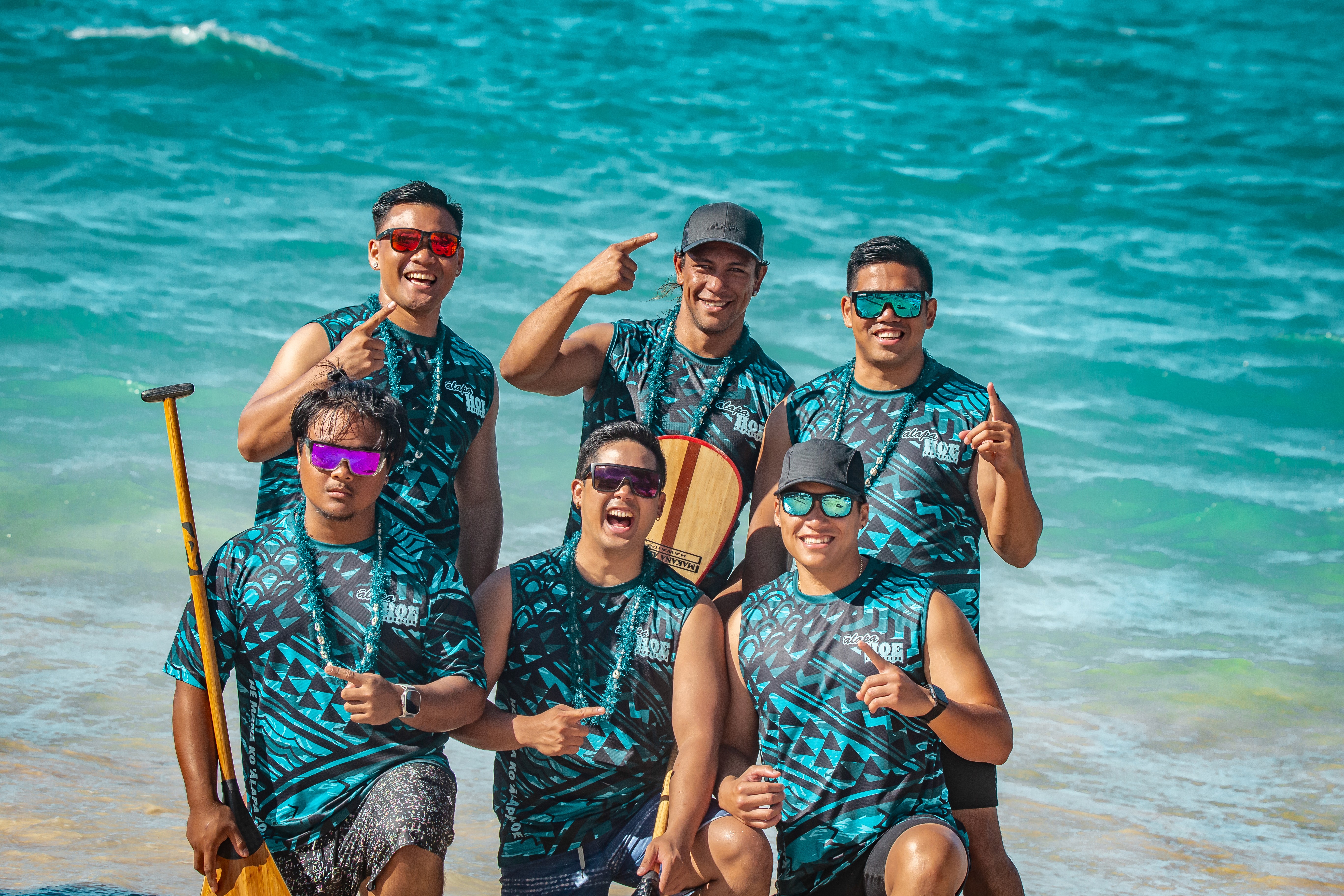A man stading with Surfboard