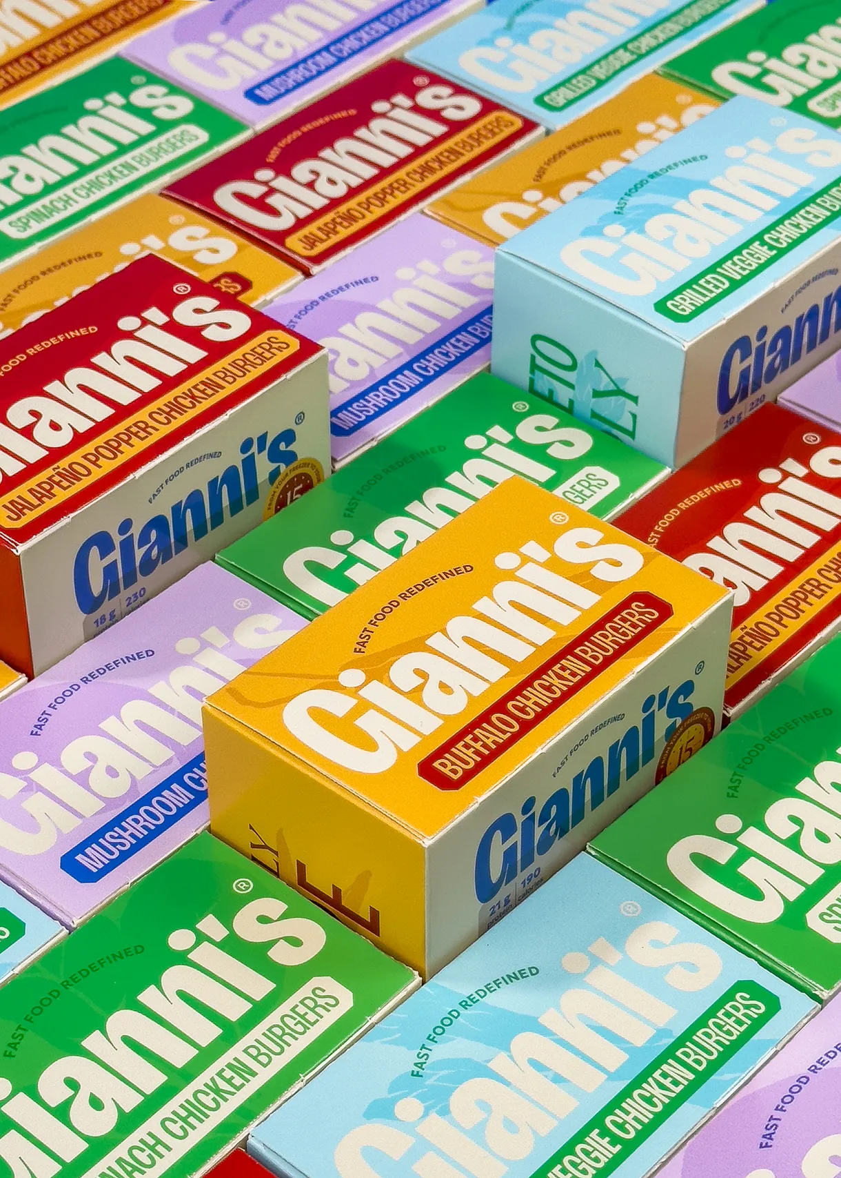 Assorted Gianni’s chicken burger packages arranged in multiple bright colorways