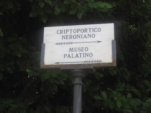 A photo of a street sign with directions to some ancient sites.