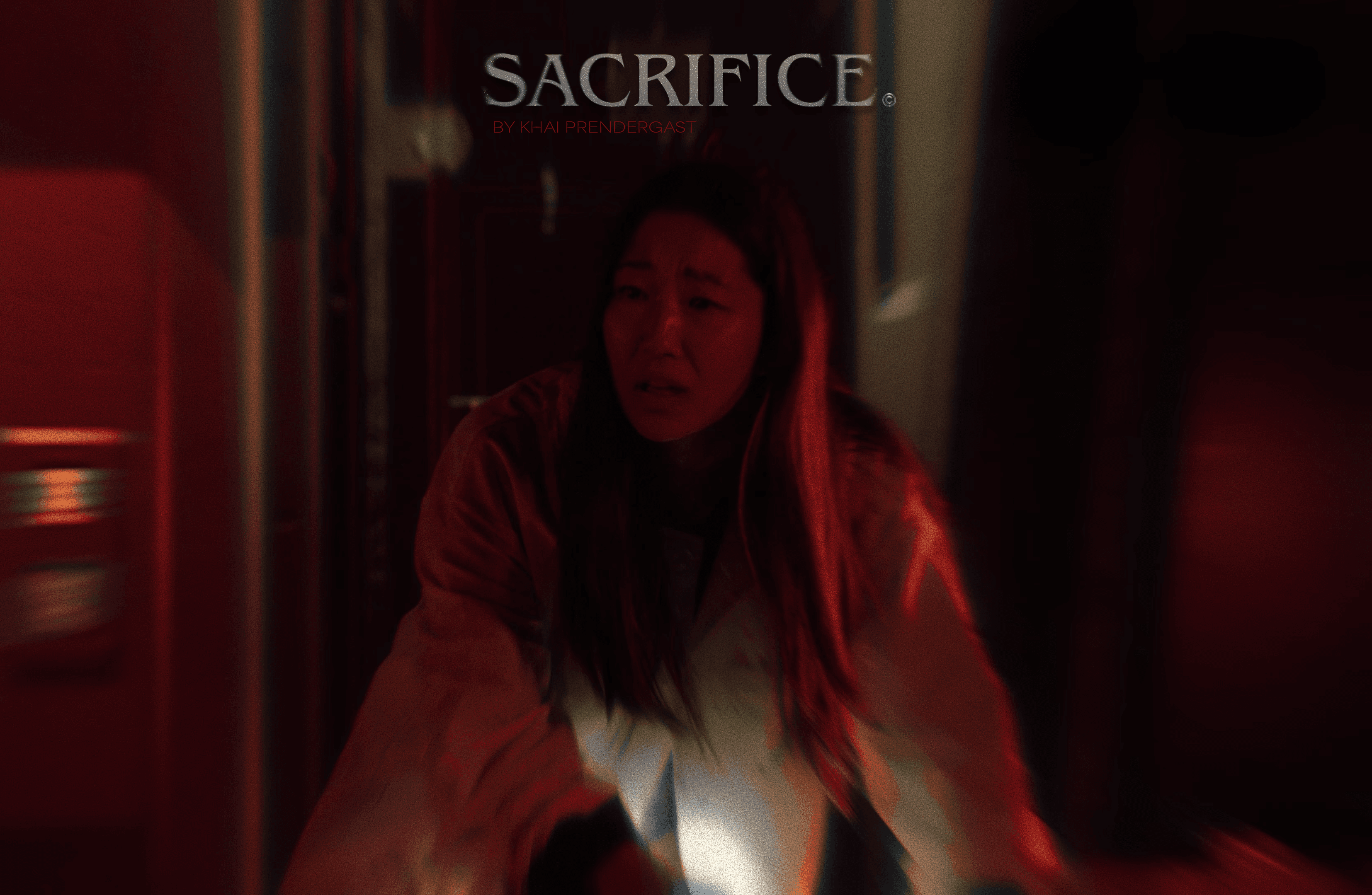 A cinematic nighttime portrait of a woman with red lipstick, captured with warm, blurred streetlights in the background.