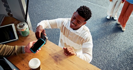 A maroon passport, a credit card, and a document are placed on a dark surface.