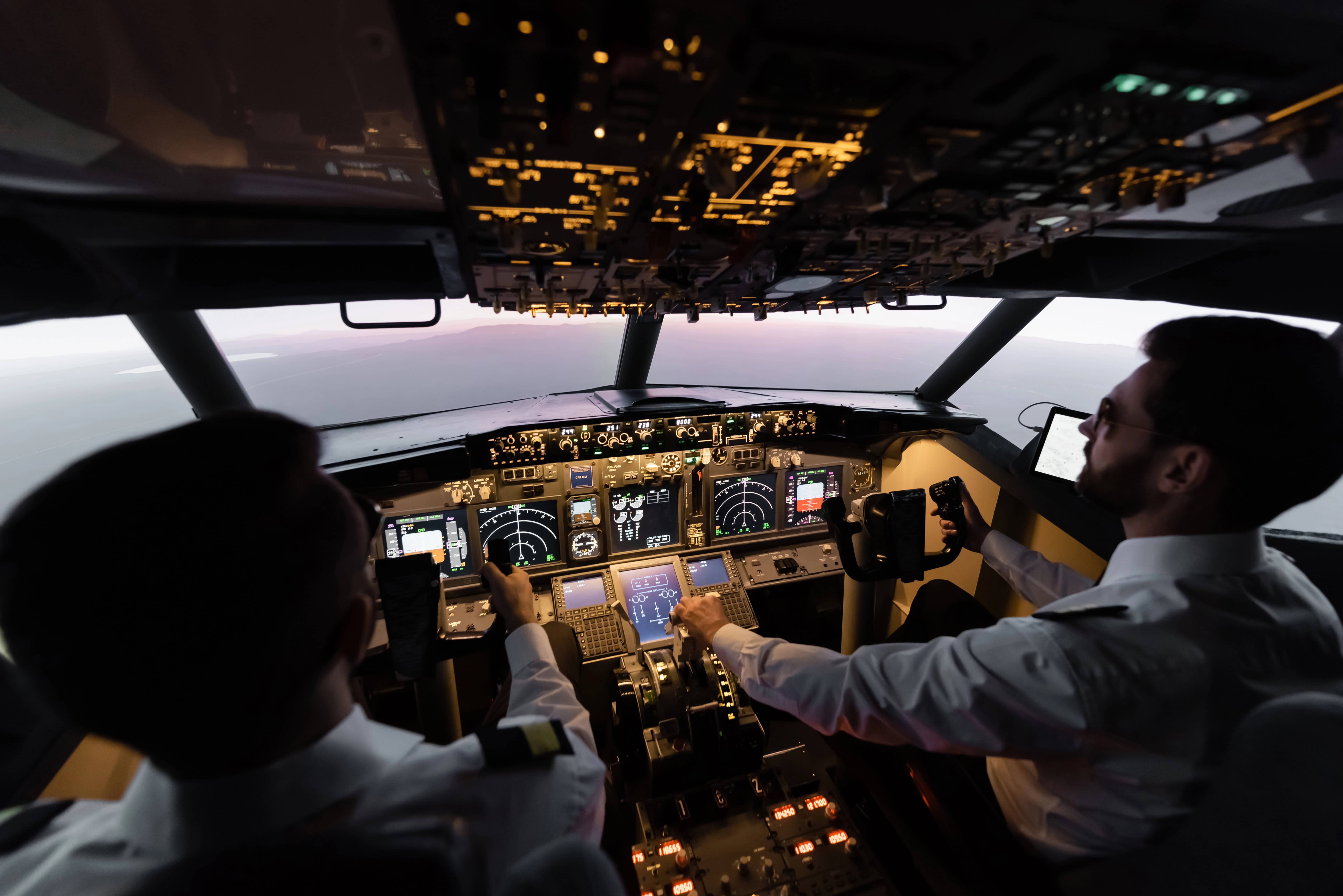 Airline pilots flying a plane and using human performance tools to reduce pilot error