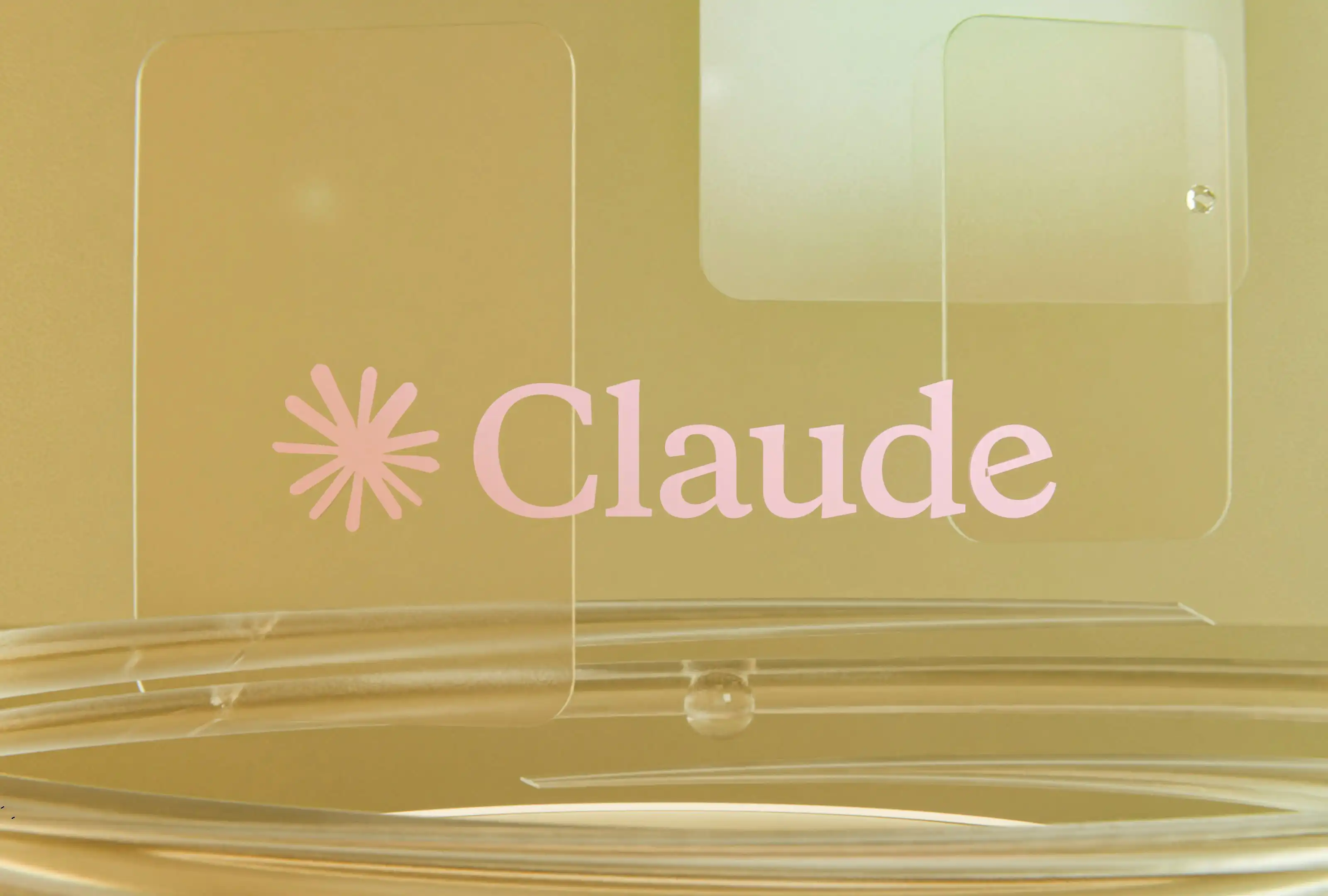 Claude AI logo displayed on transparent glass panels