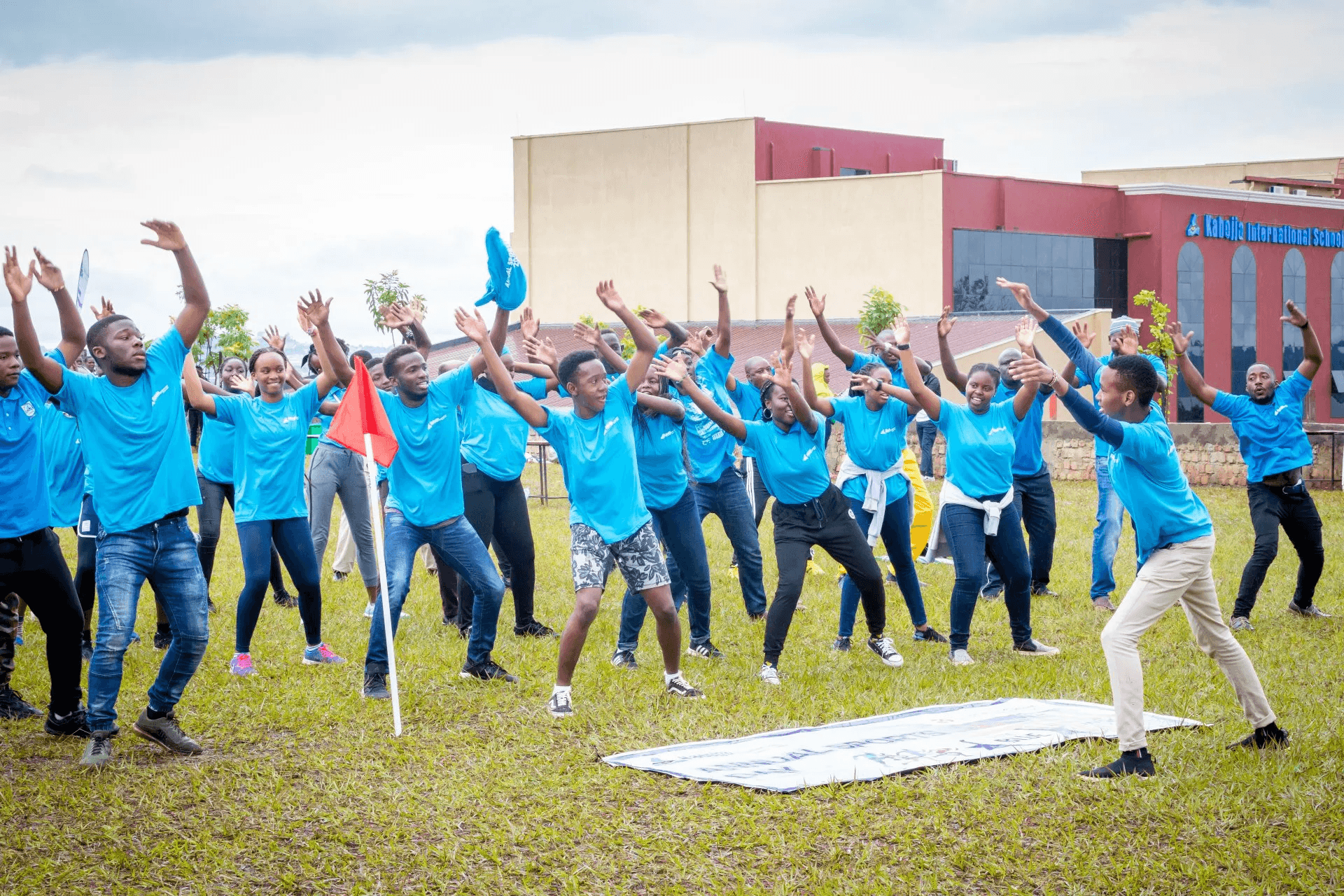 Two cheerful students are balancing books on their heads, smiling and laughing