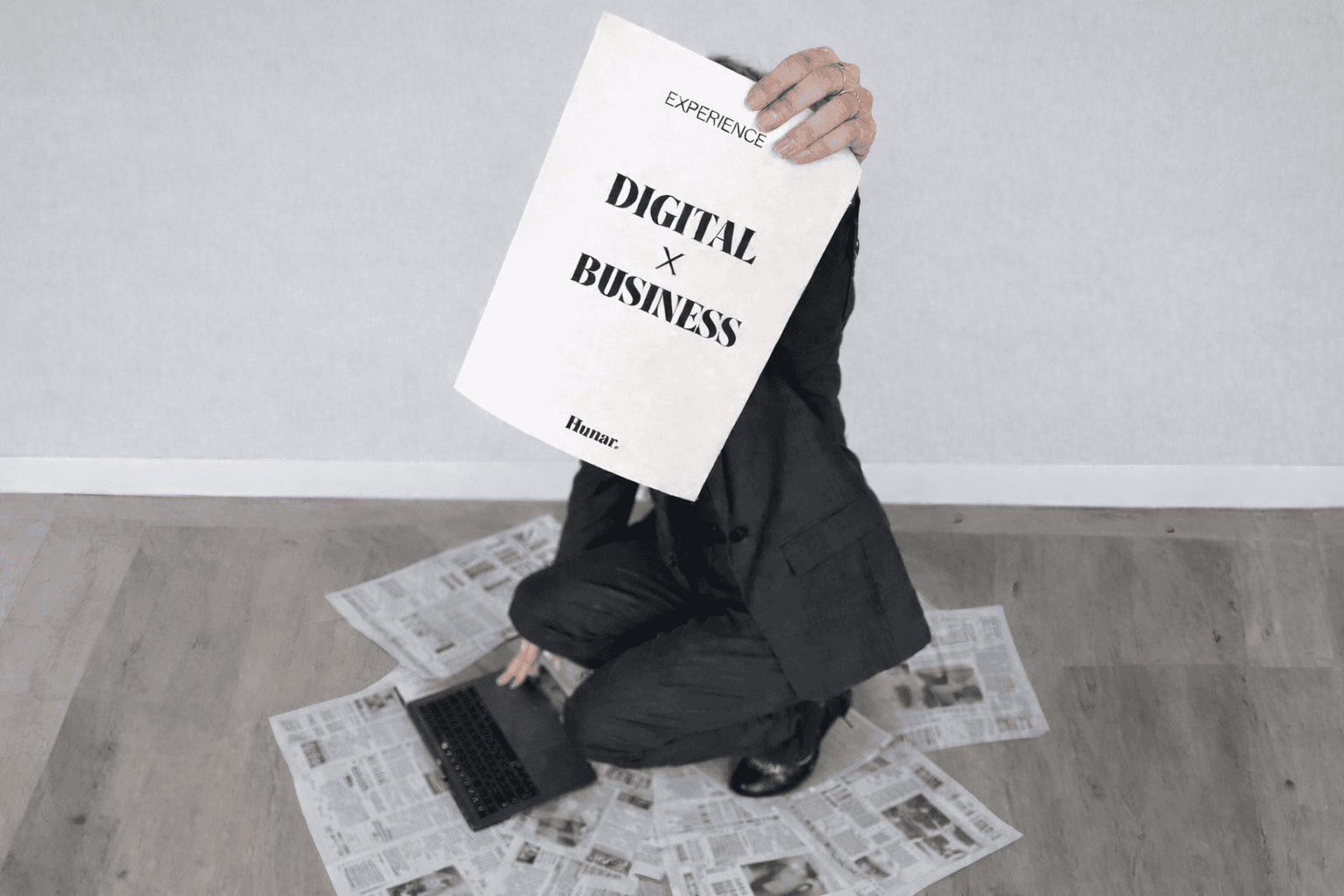 A businessman displays a paper with "Digital Business" written on it, representing the shift towards digital entrepreneurship.