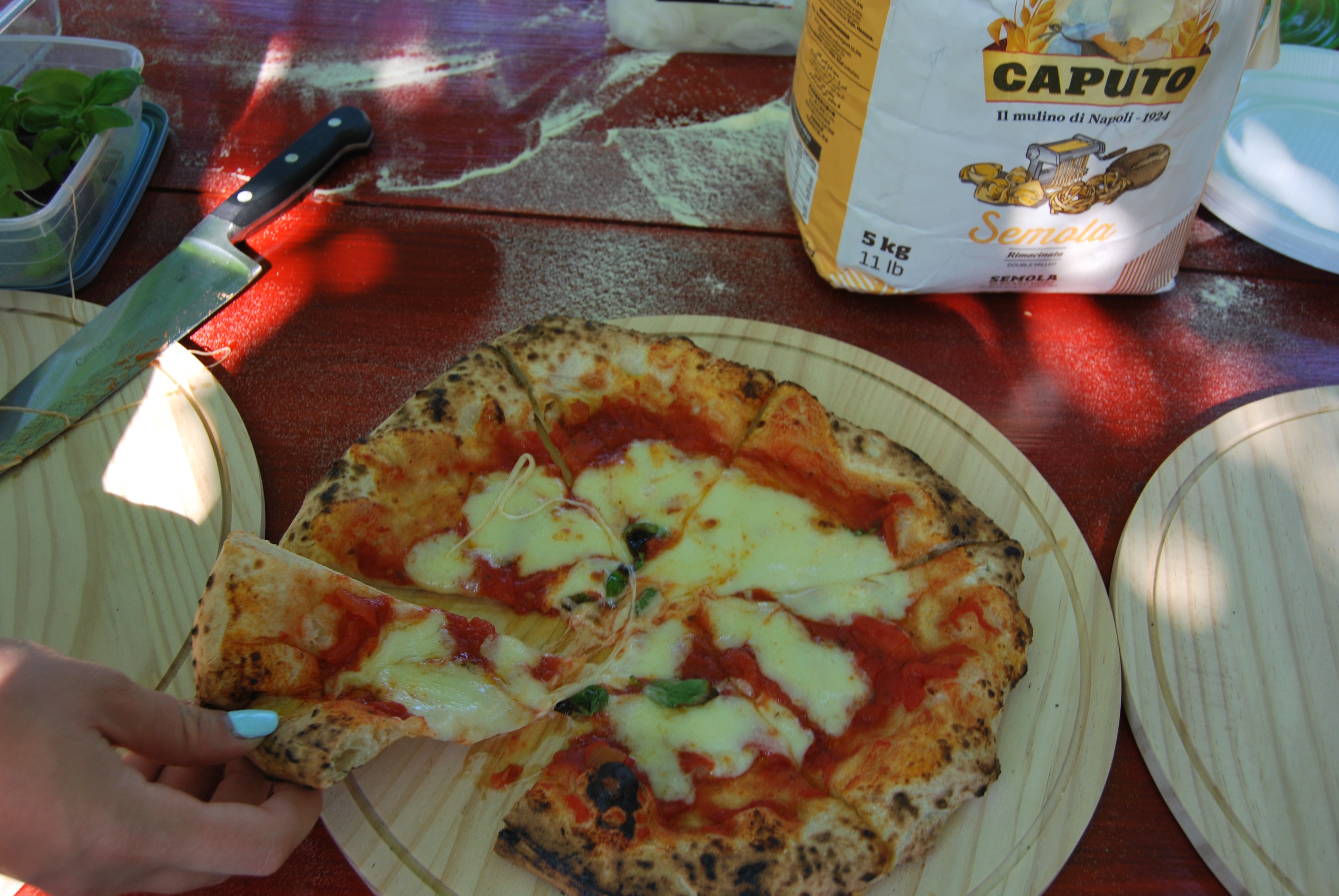 Overhead shot of a slice of pizza being taken