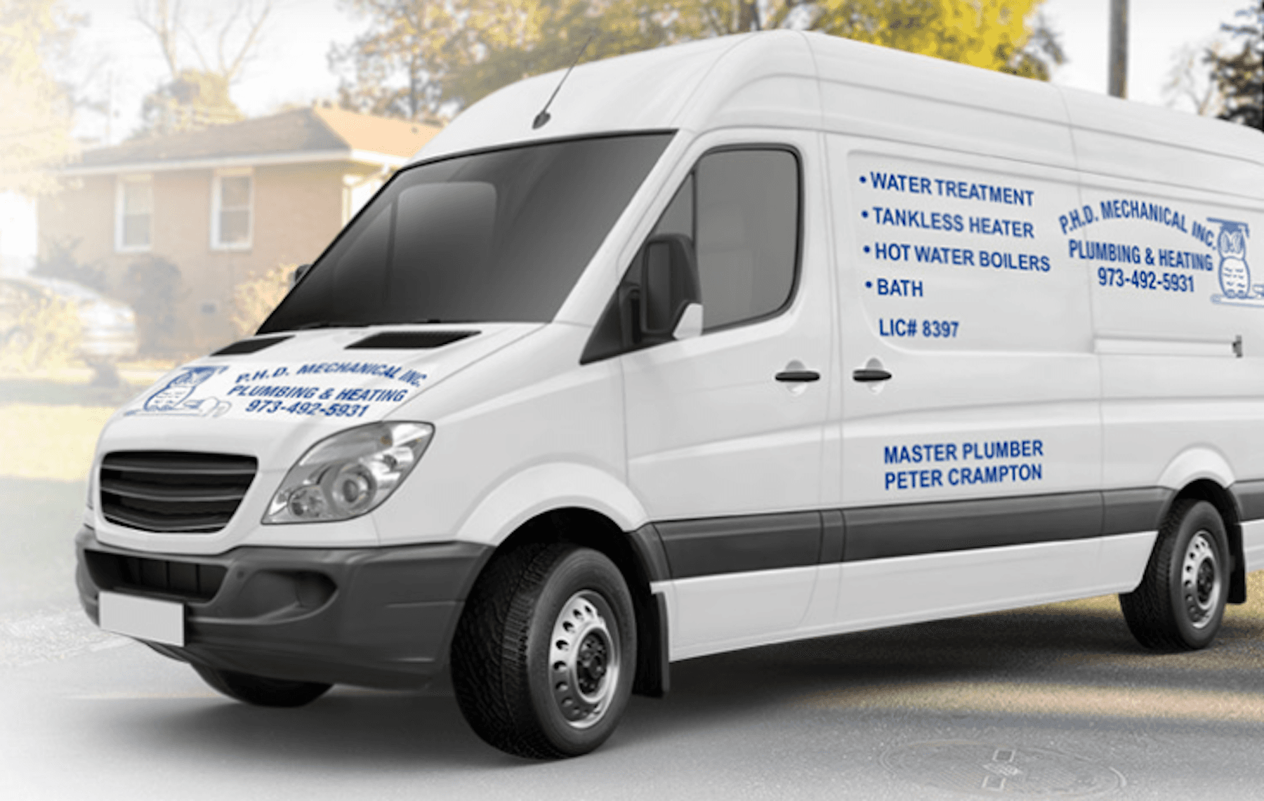 PHD Mechanical service van branded with plumbing and heating services parked in a residential New Jersey neighborhood.
