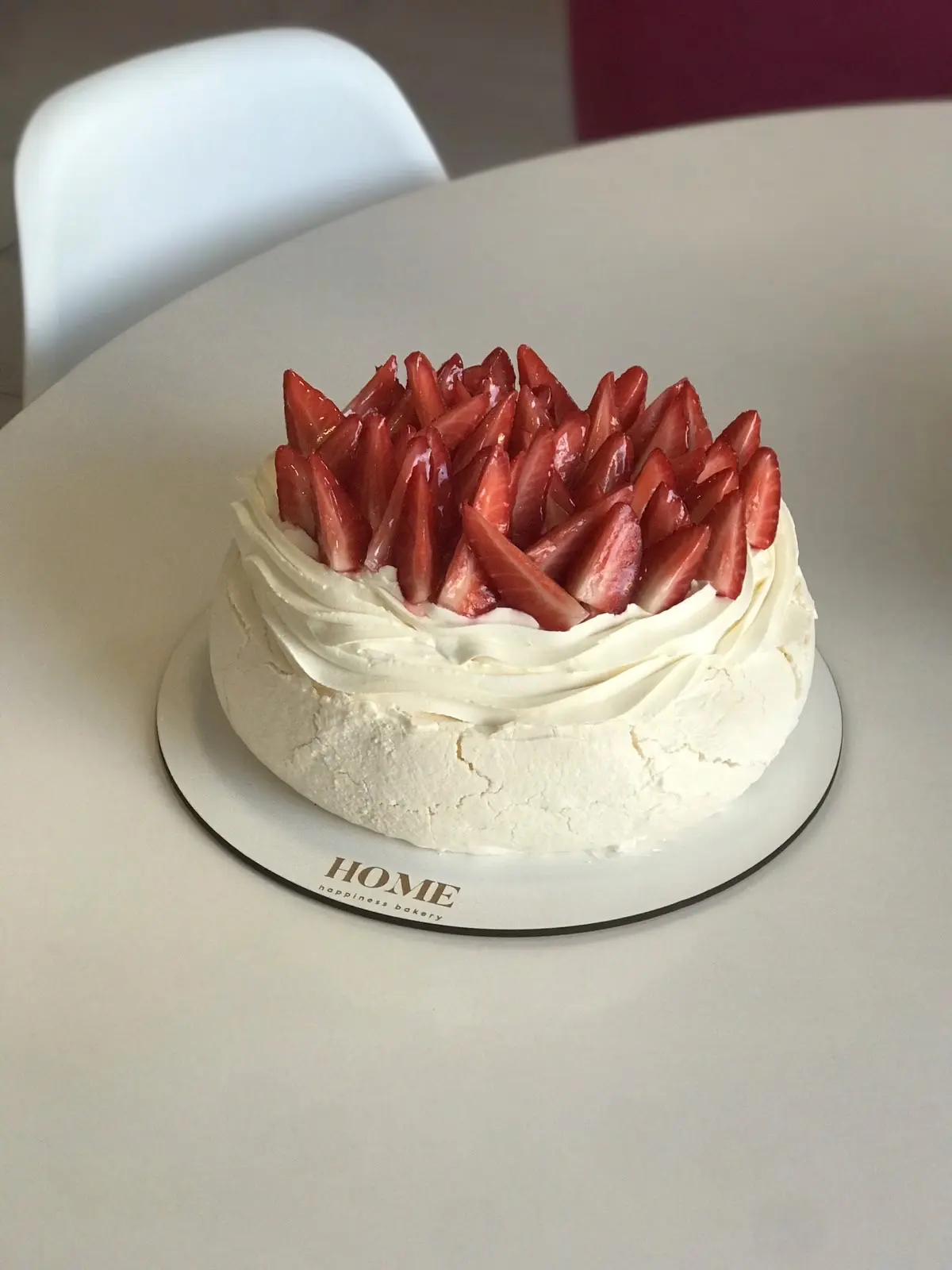White layer cake with fresh strawberries on top
