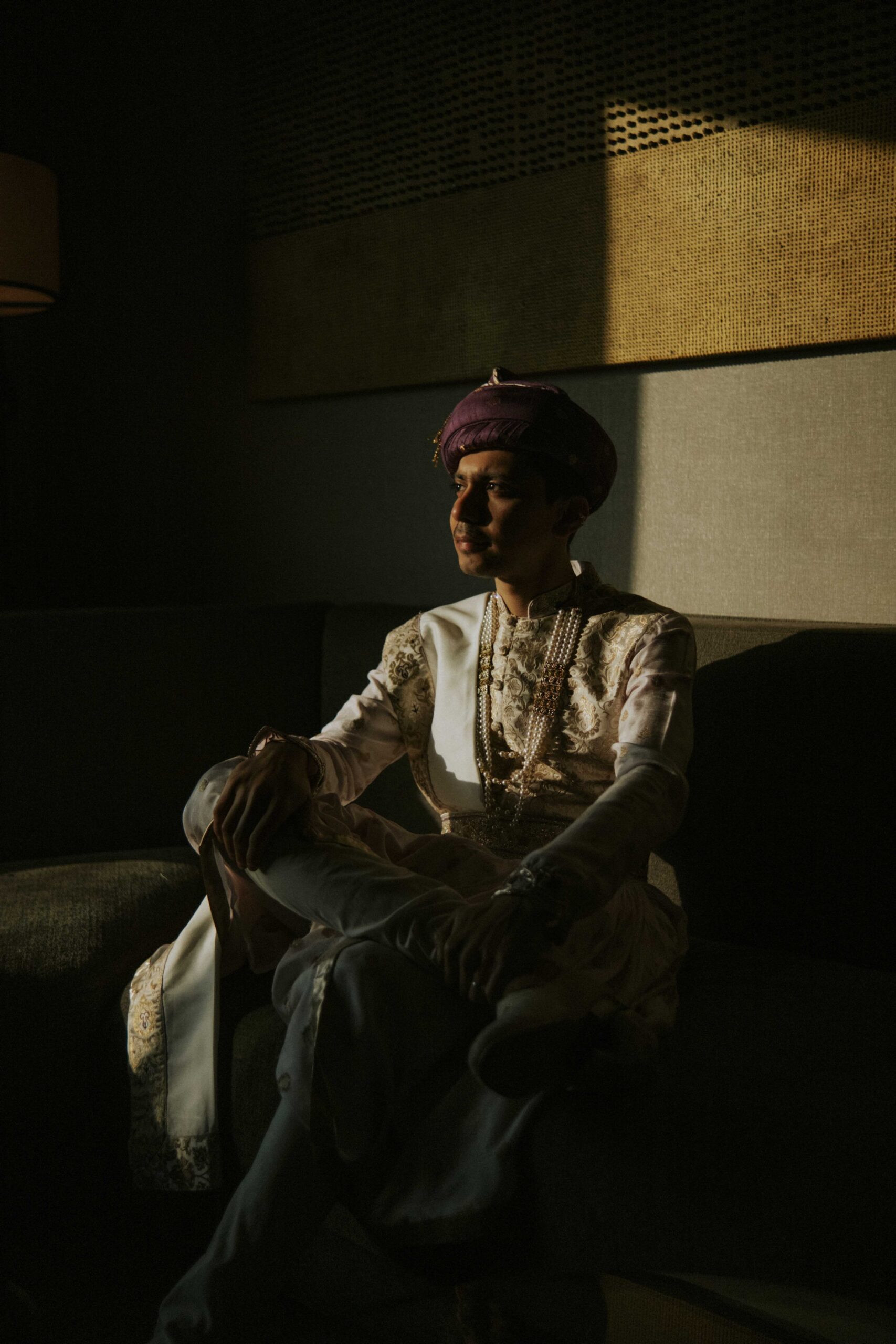 Groom seated in shadow
