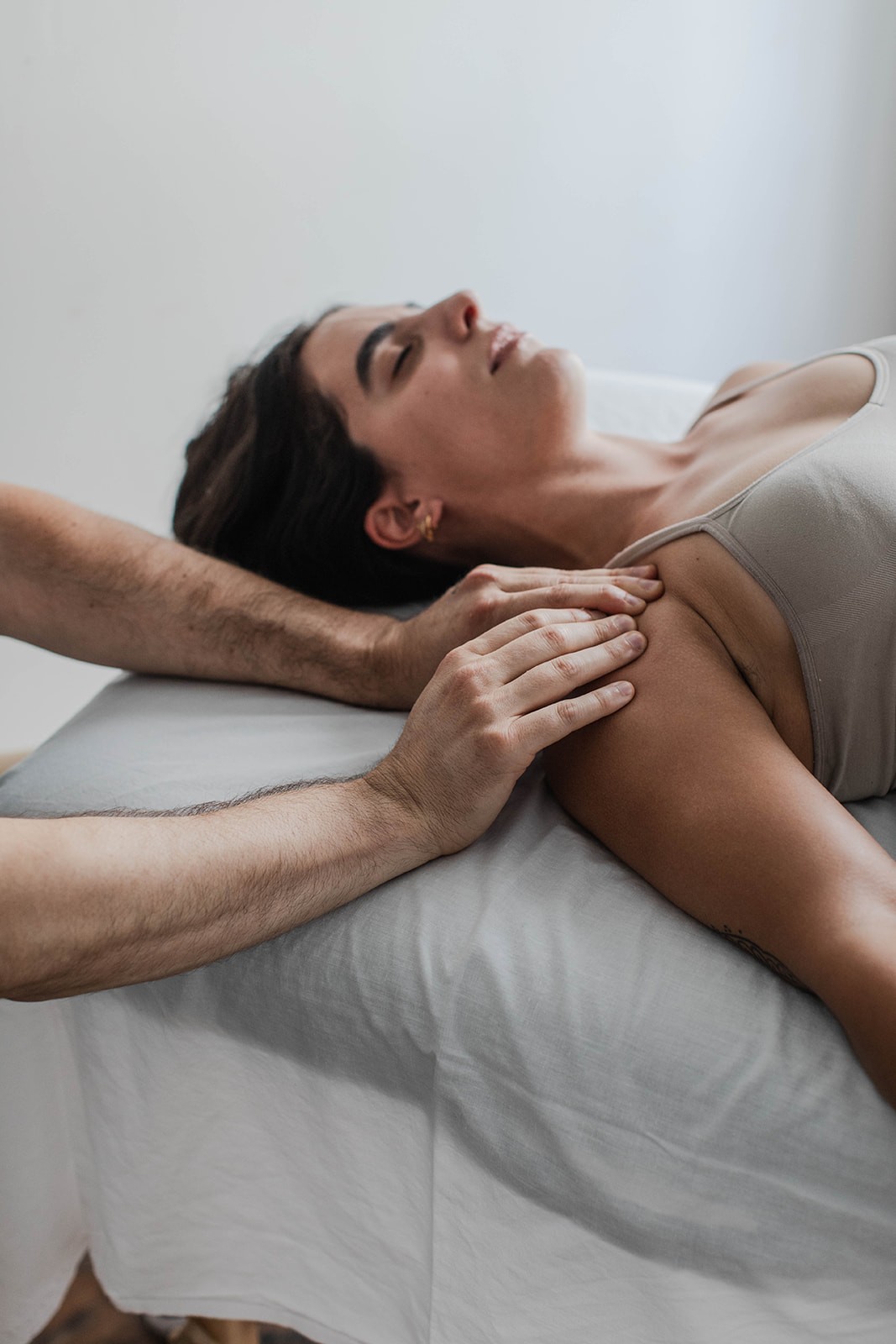 Hands-on Rolfing adjustment for athlete shoulder pain relief in Sacramento.