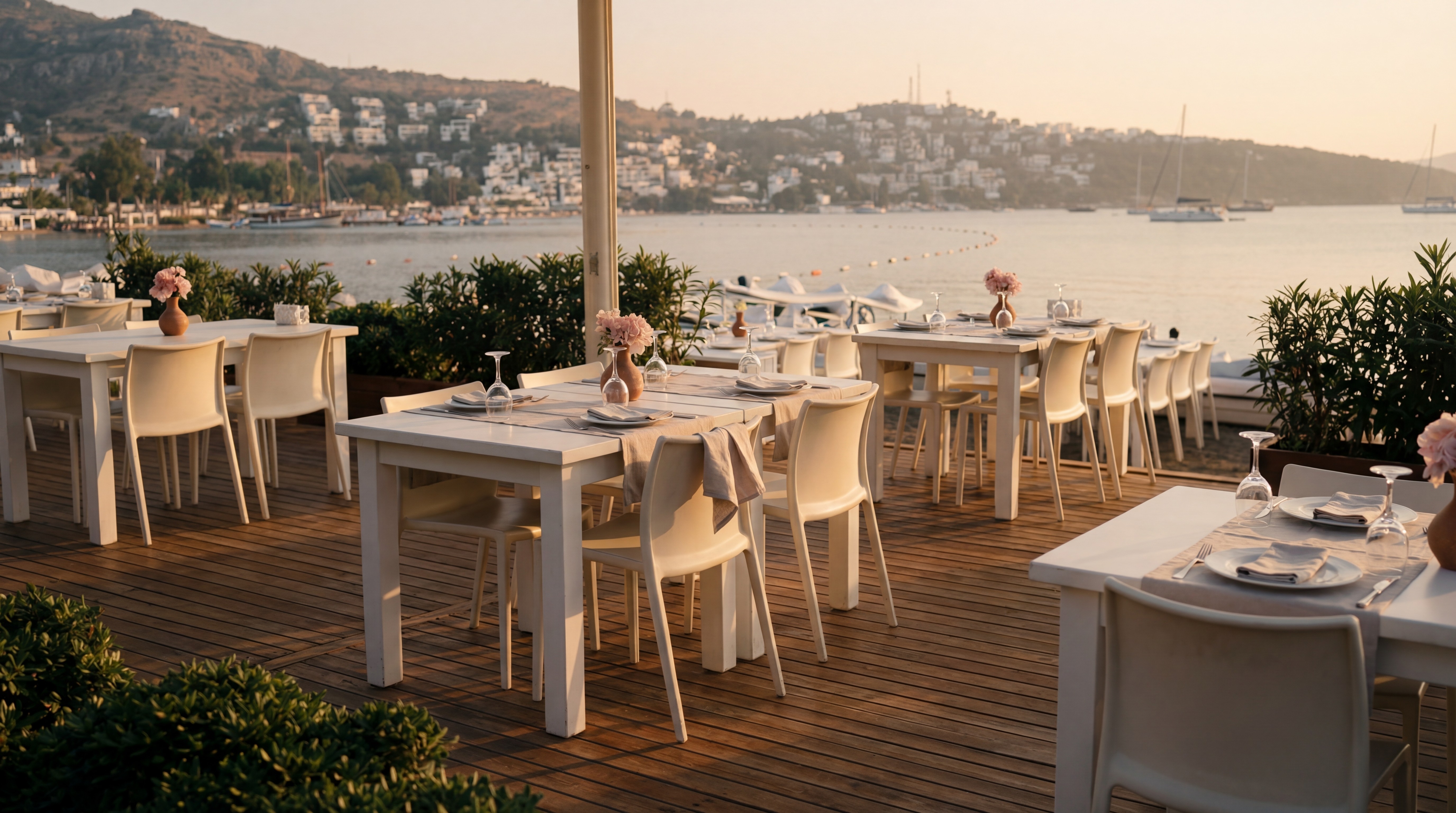 Seaside seafood restaurant in Gümüşlük Bodrum with tables by the water and sunset views