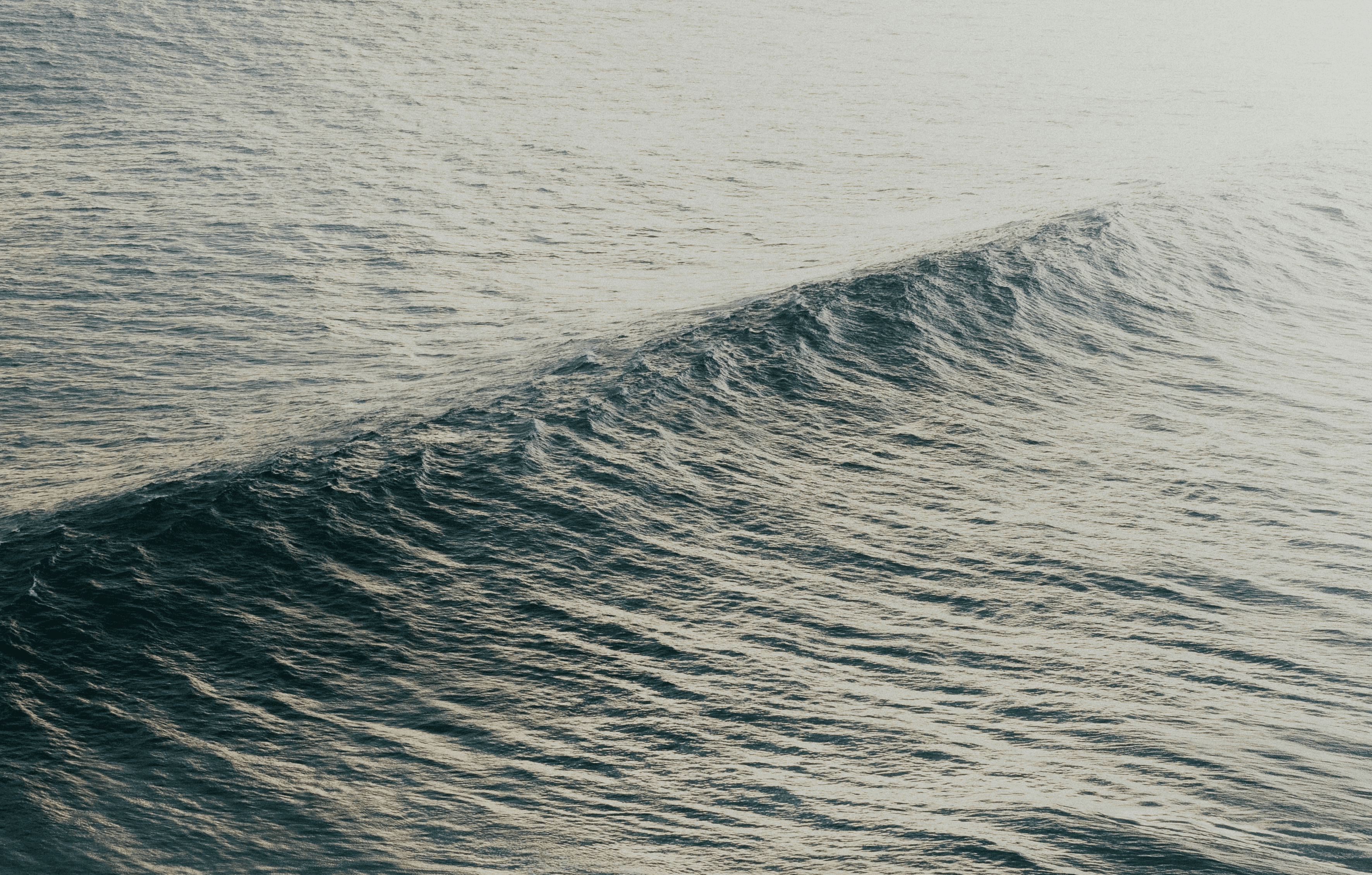 ocean waves crashing on shore during daytime