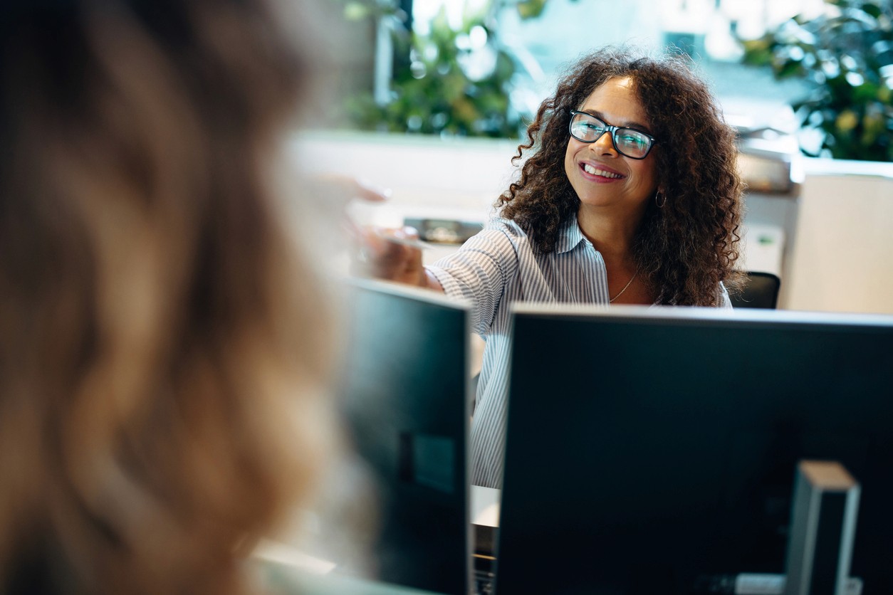Close-up of a person looking down in soft light, wearing a small hoop earring
