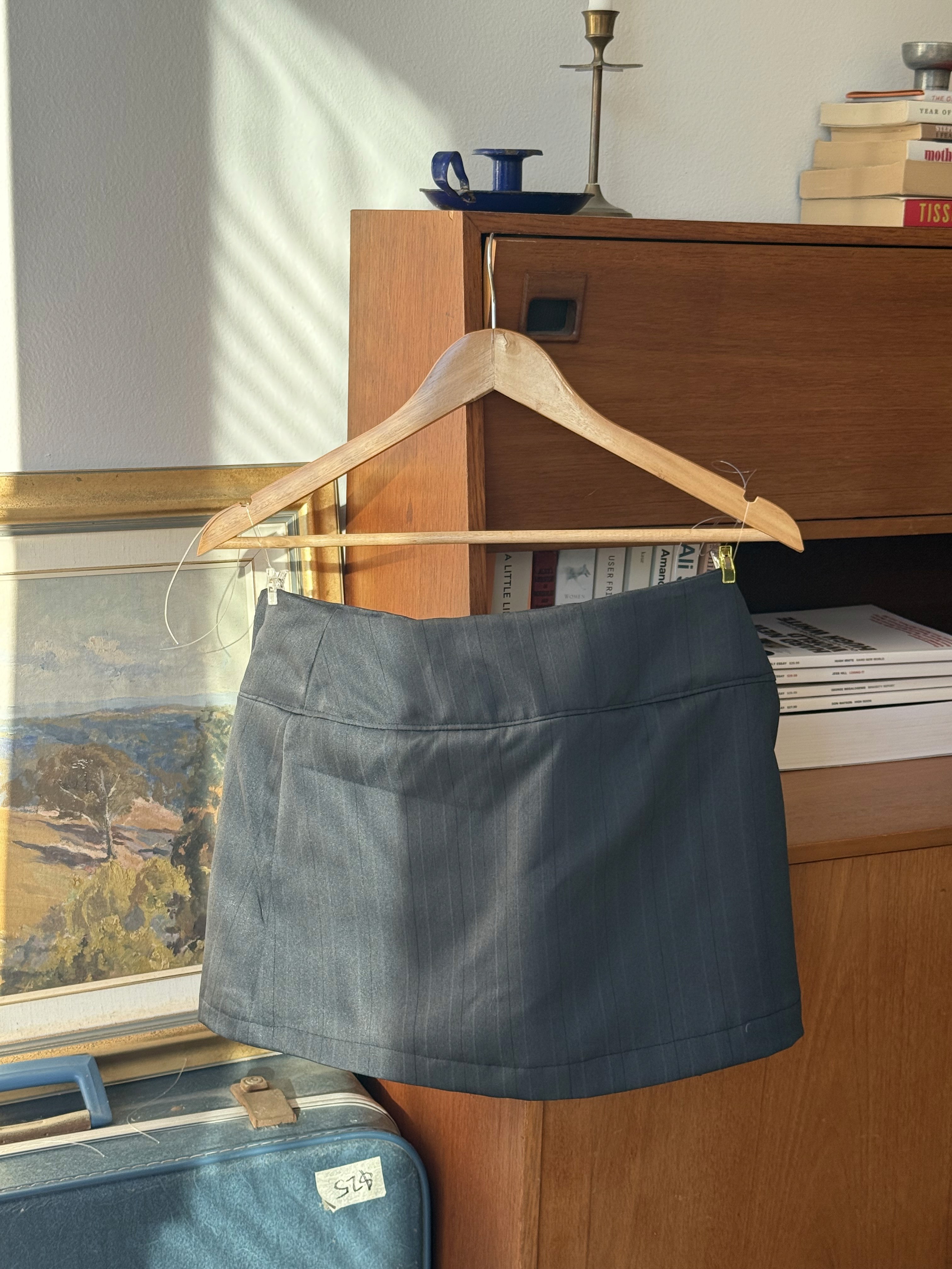 Back of black pin-stripe short skirt 